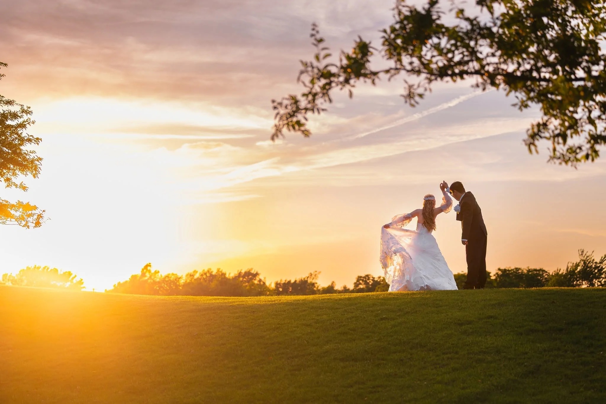 Bride and groom dancing during sunset on golf course at Warwick Hills in Grand Blanc, Michigan