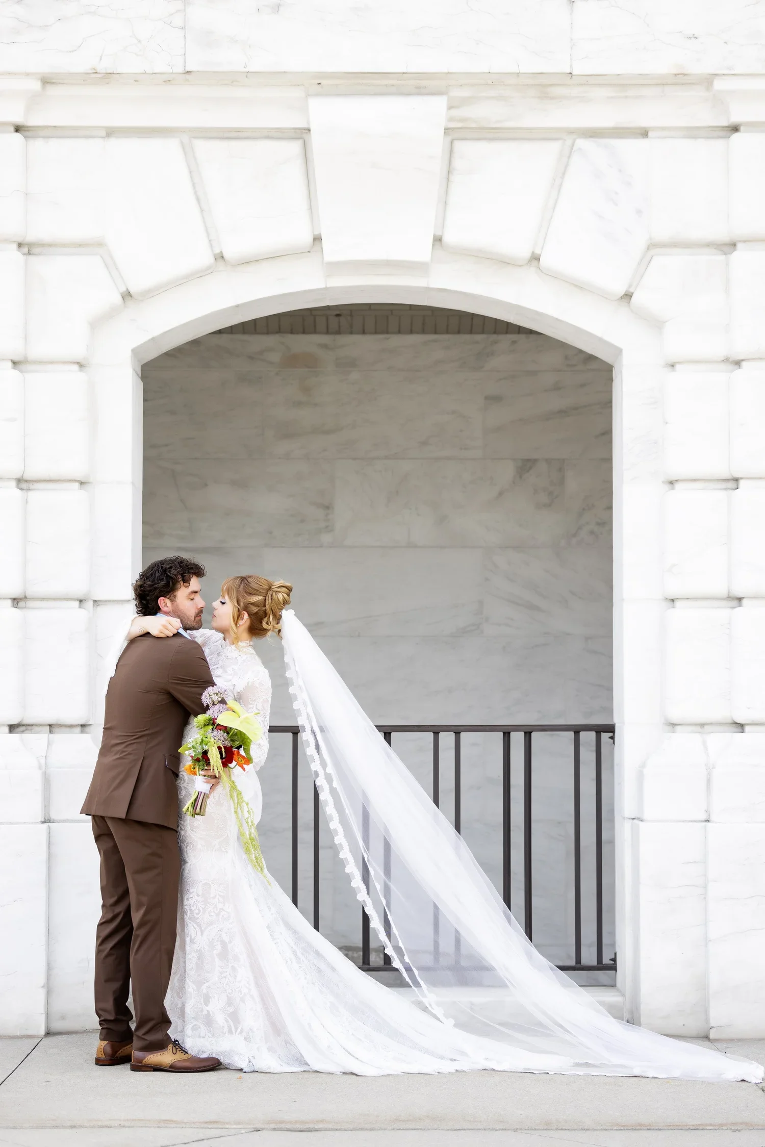 Bride and groom embracing at Detroit Institute of Arts in Southeast Michigan