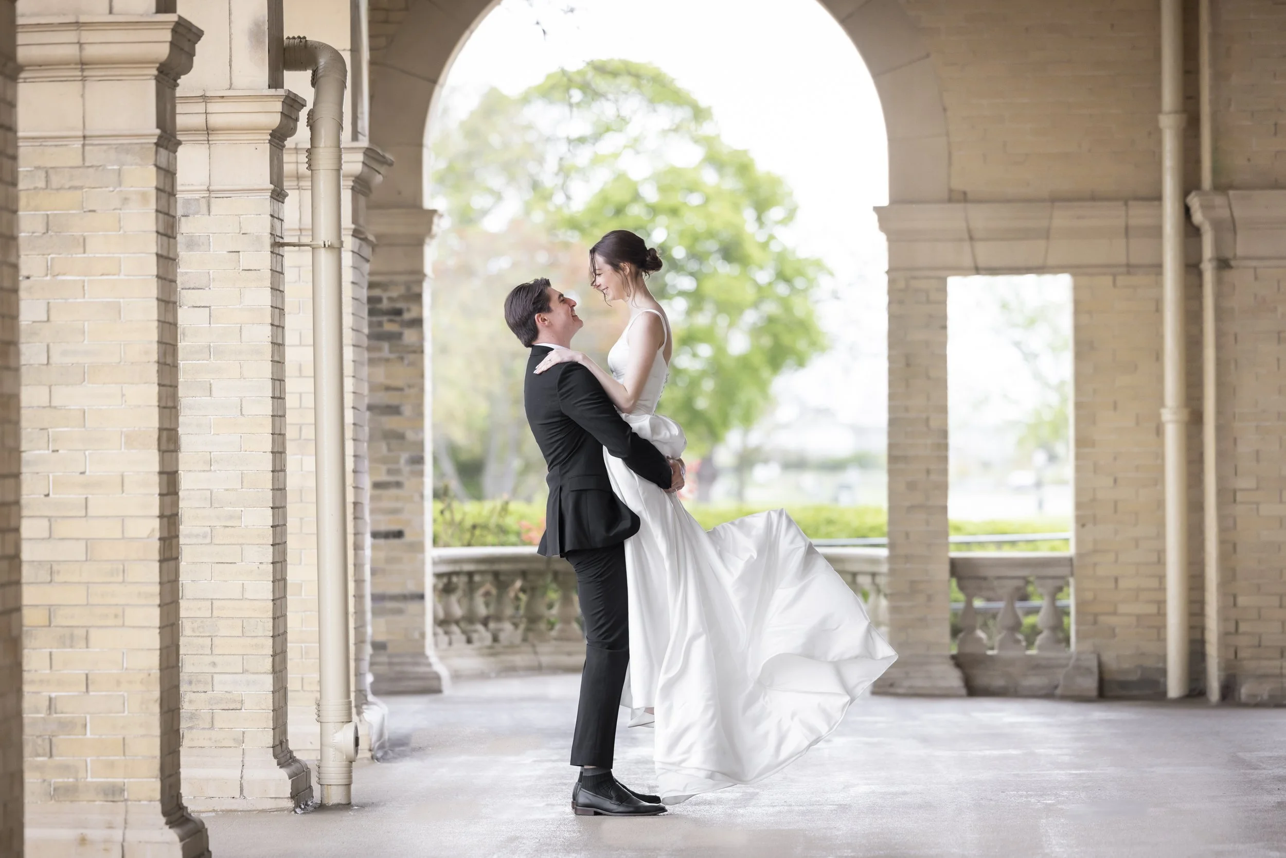 Groom holding bride at Belle Isle Casino in Detroit Michigan
