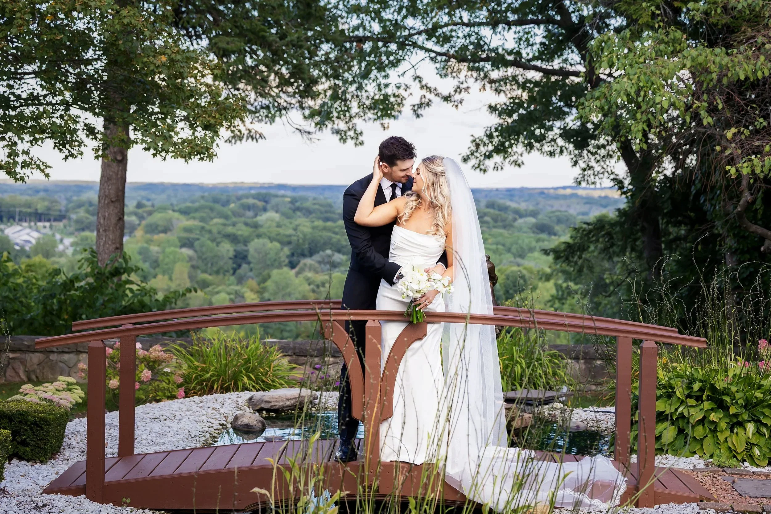 Bride and groom on the bridge at Pine Knob Mansion in Clarkston, Michigan