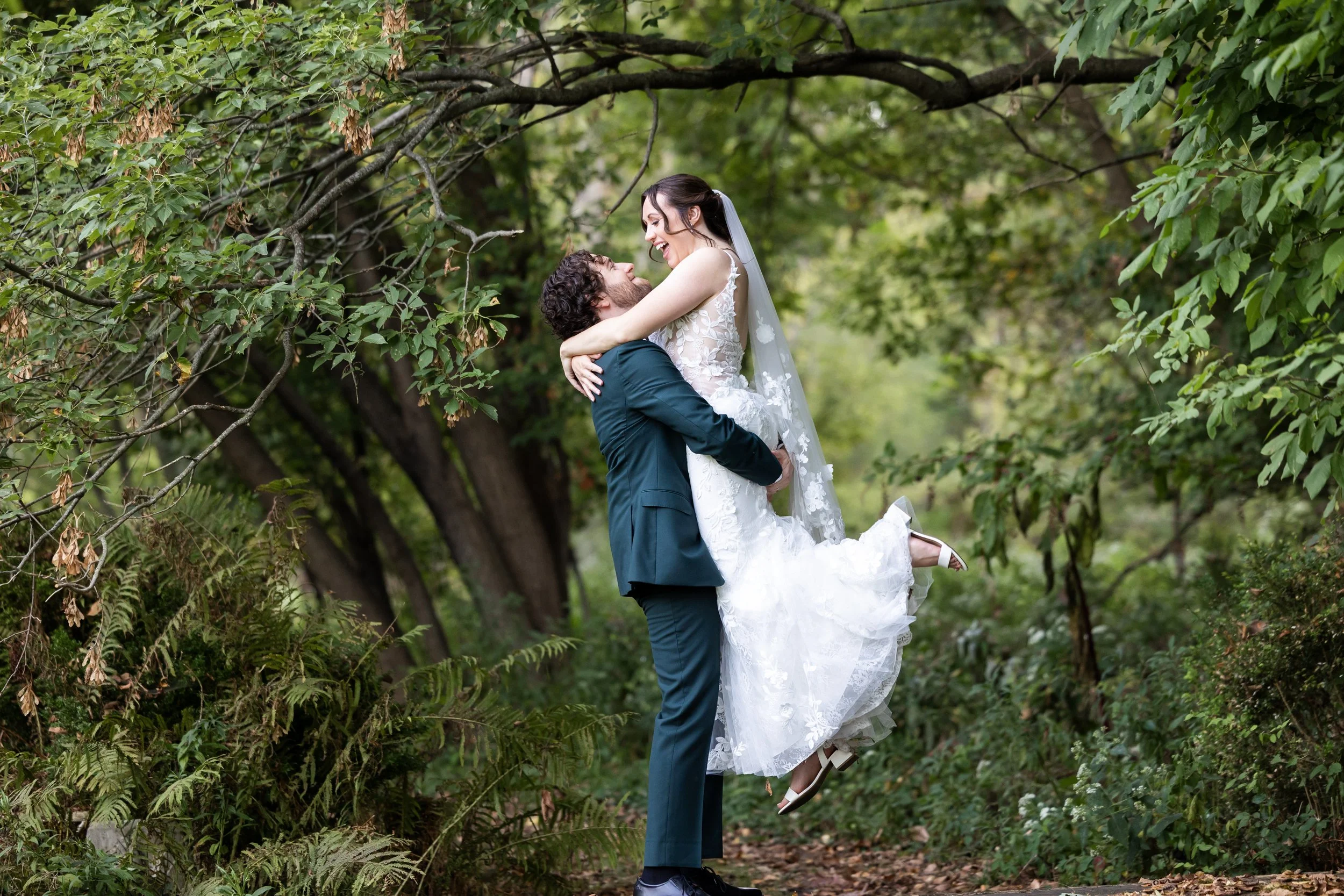 Bride and groom stand together in the garden at Wellers Weddings in Saline, Michigan