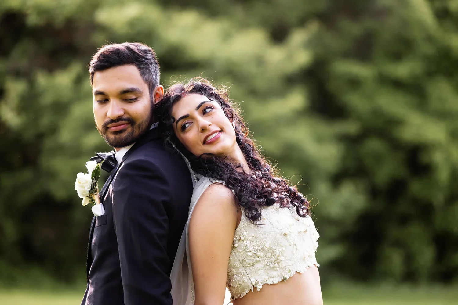 Bride and groom leaning back-to-back in Ann Arbor, Michigan