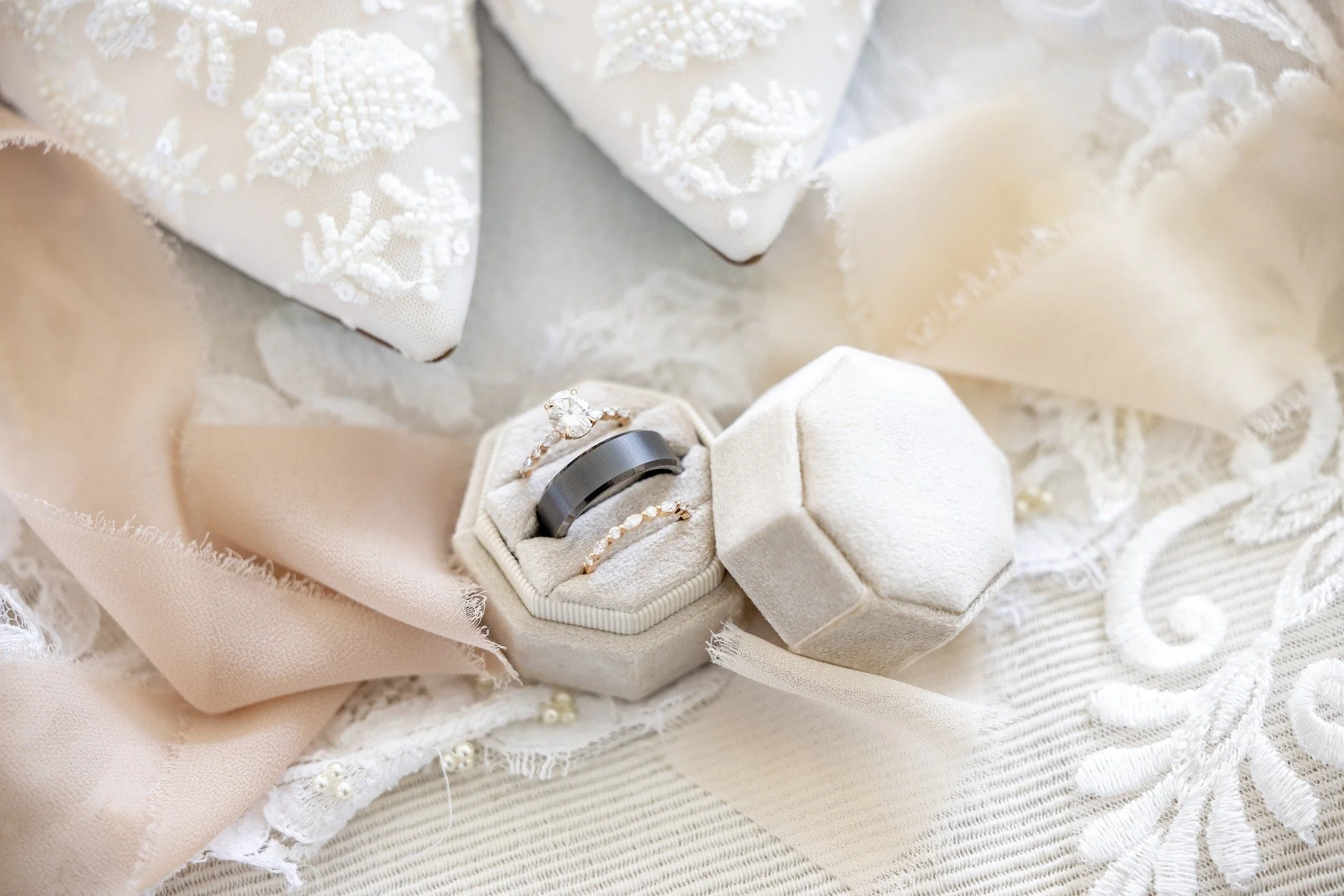 closeup detail wedding photo rings, shoes, and ribbons