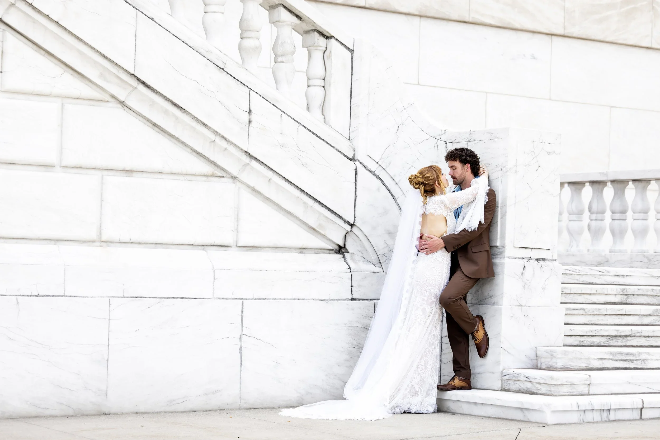 Bride and groom embrace at Detroit Institute of Arts