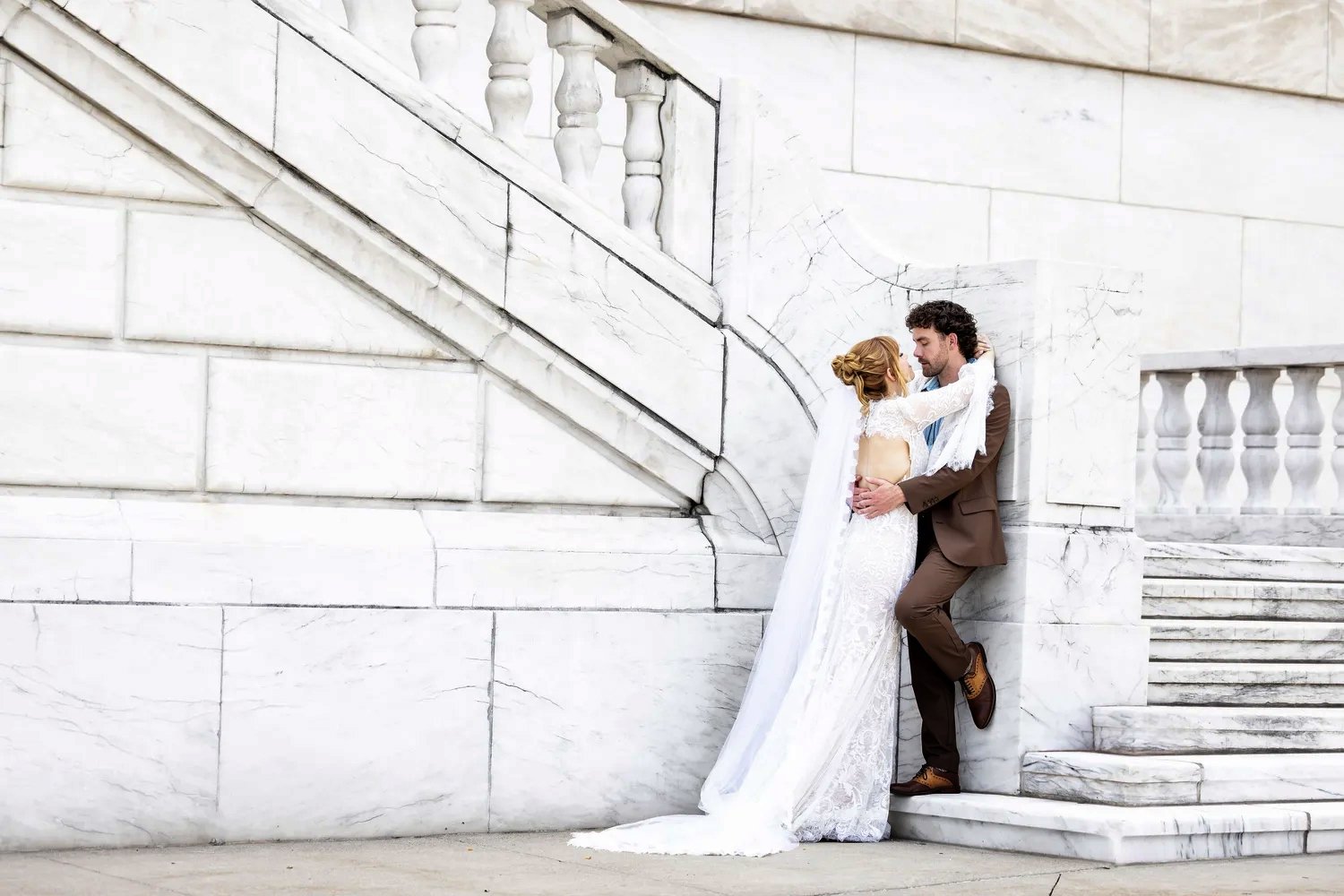 Bride and groom embracing at Detroit Institute of Arts in Detroit, Michigan
