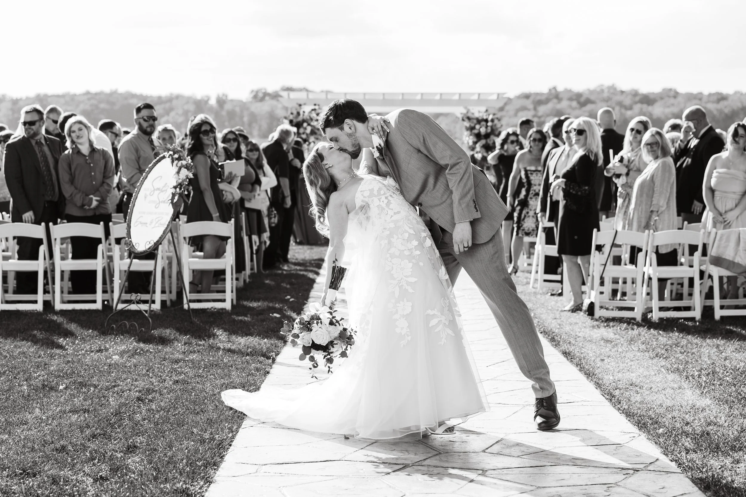 Groom dips bride at the end of the aisle during their romantic Waldenwoods wedding, capturing a joyful and timeless wedding day moment.