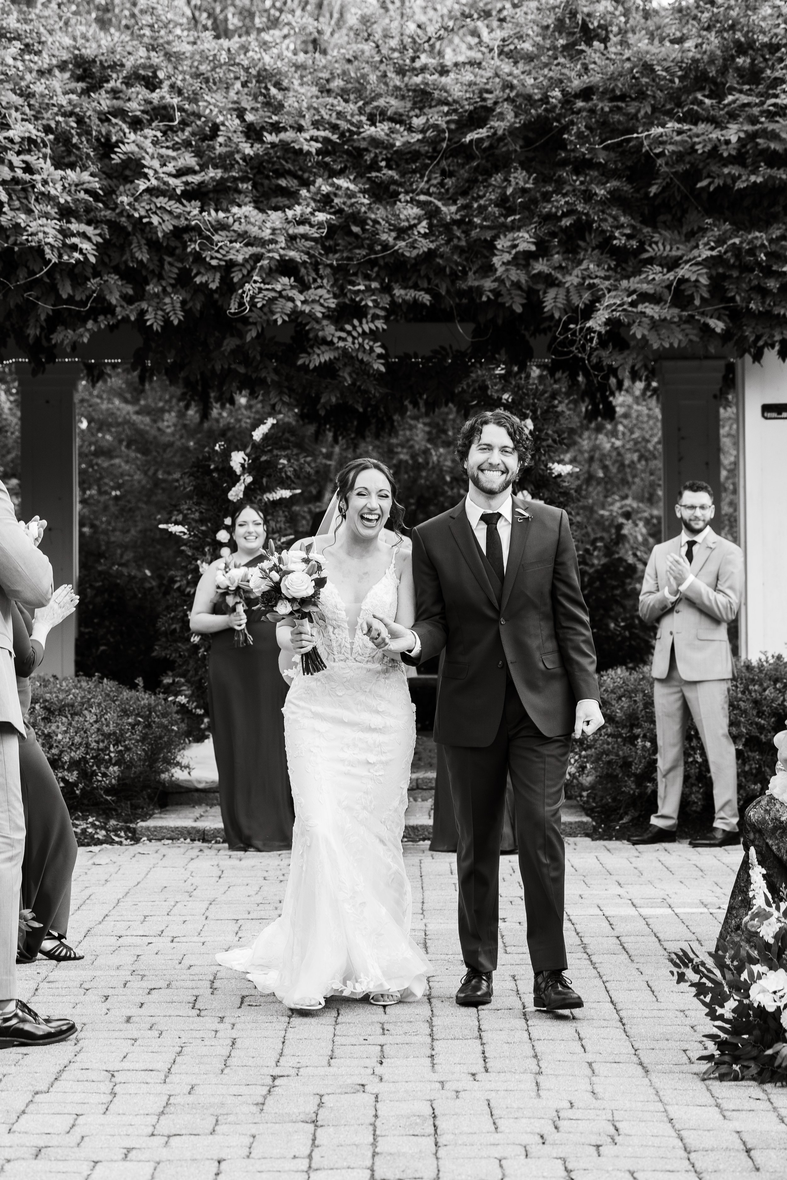 black and white photo of the bride and groom exiting the ceremony in Saline, Michigan
