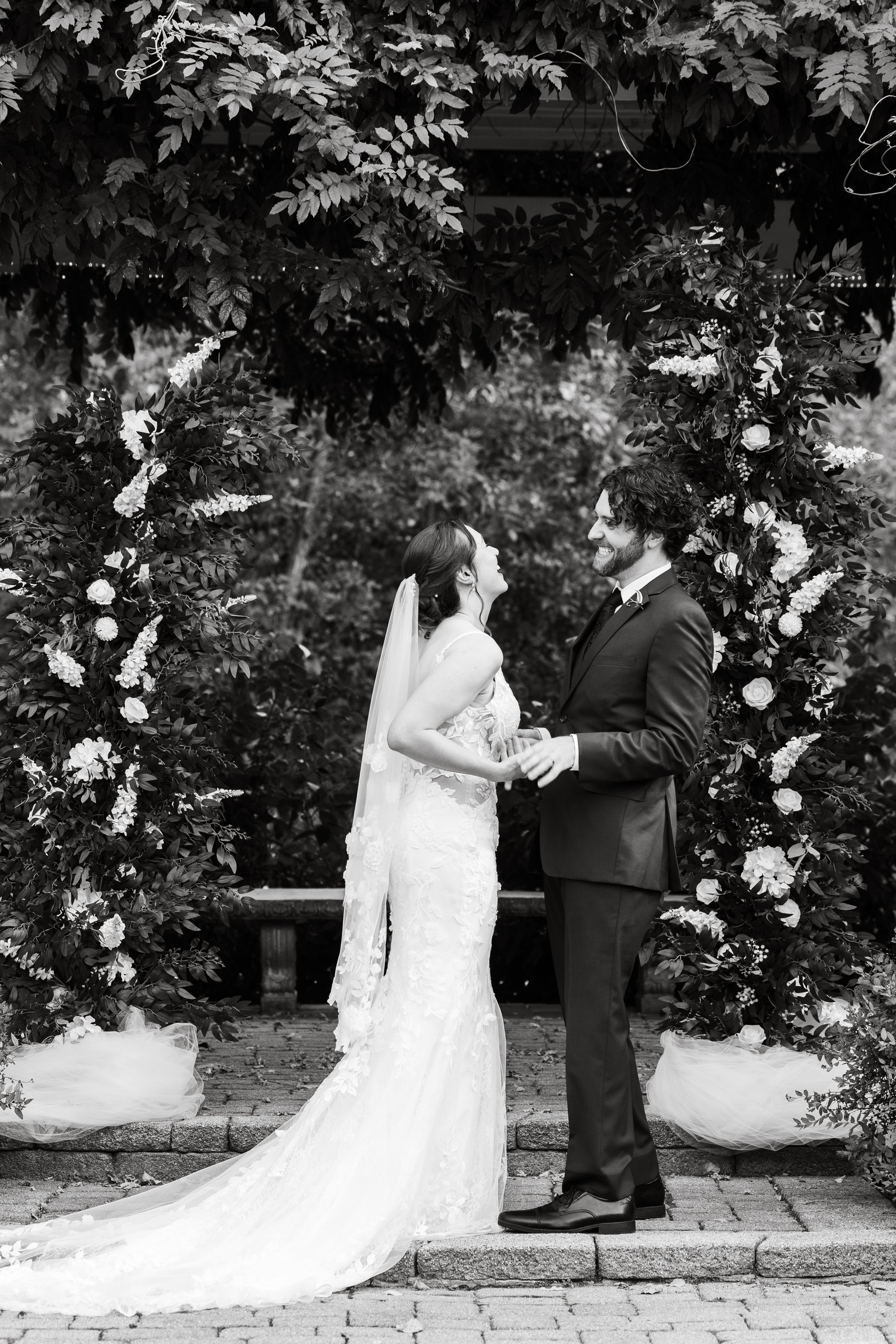 black and white photo of bride and groom during ceremony at wellers weddings in saline, michigan