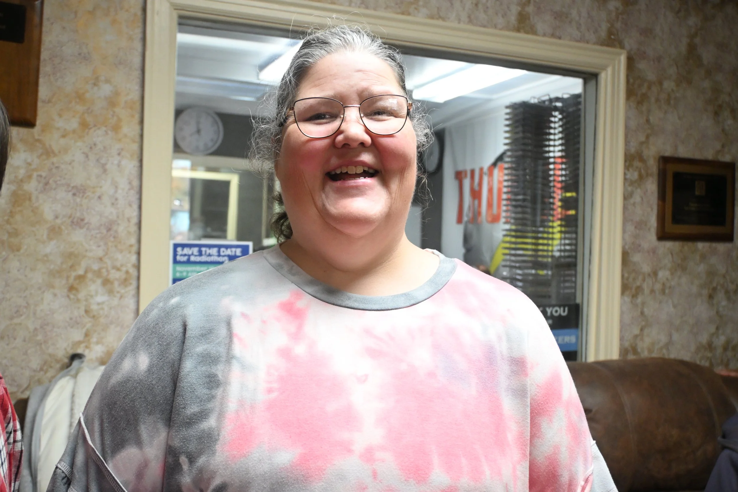A woman we support in the lobby area, waiting for her turn to go the air during the SJCS Radiothon