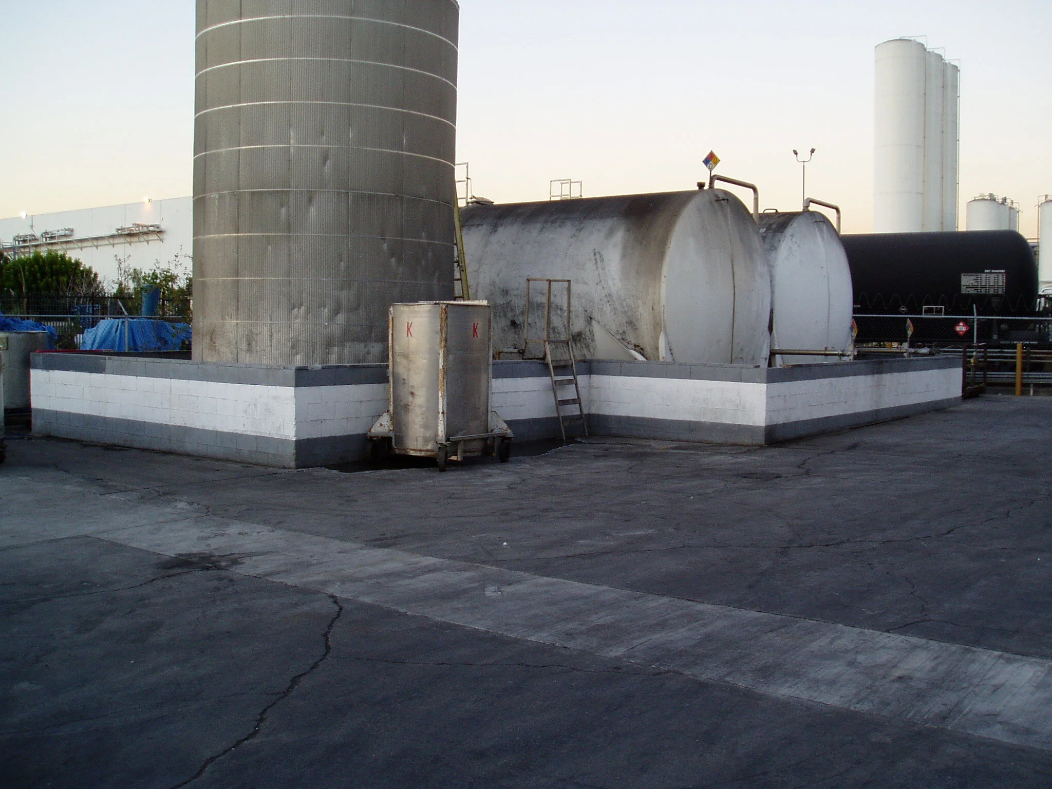 Compliance review and permitting may involve evaluation of containment systems for industrial storage tanks