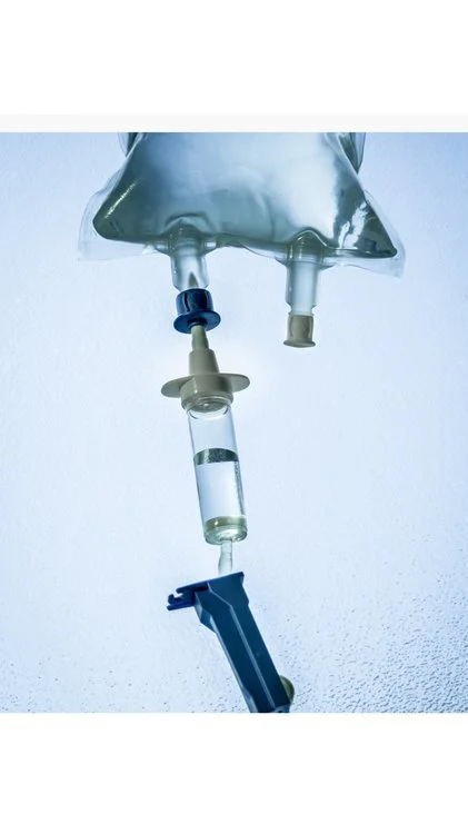 Close-up of a medical IV drip with fluid bag