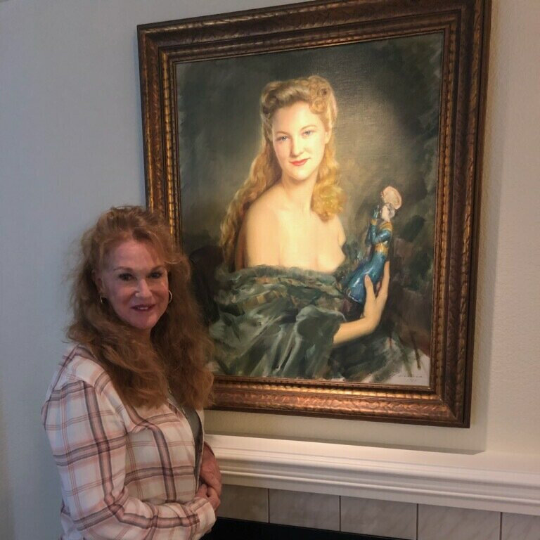 Jan Andrews next to Mother's portrait