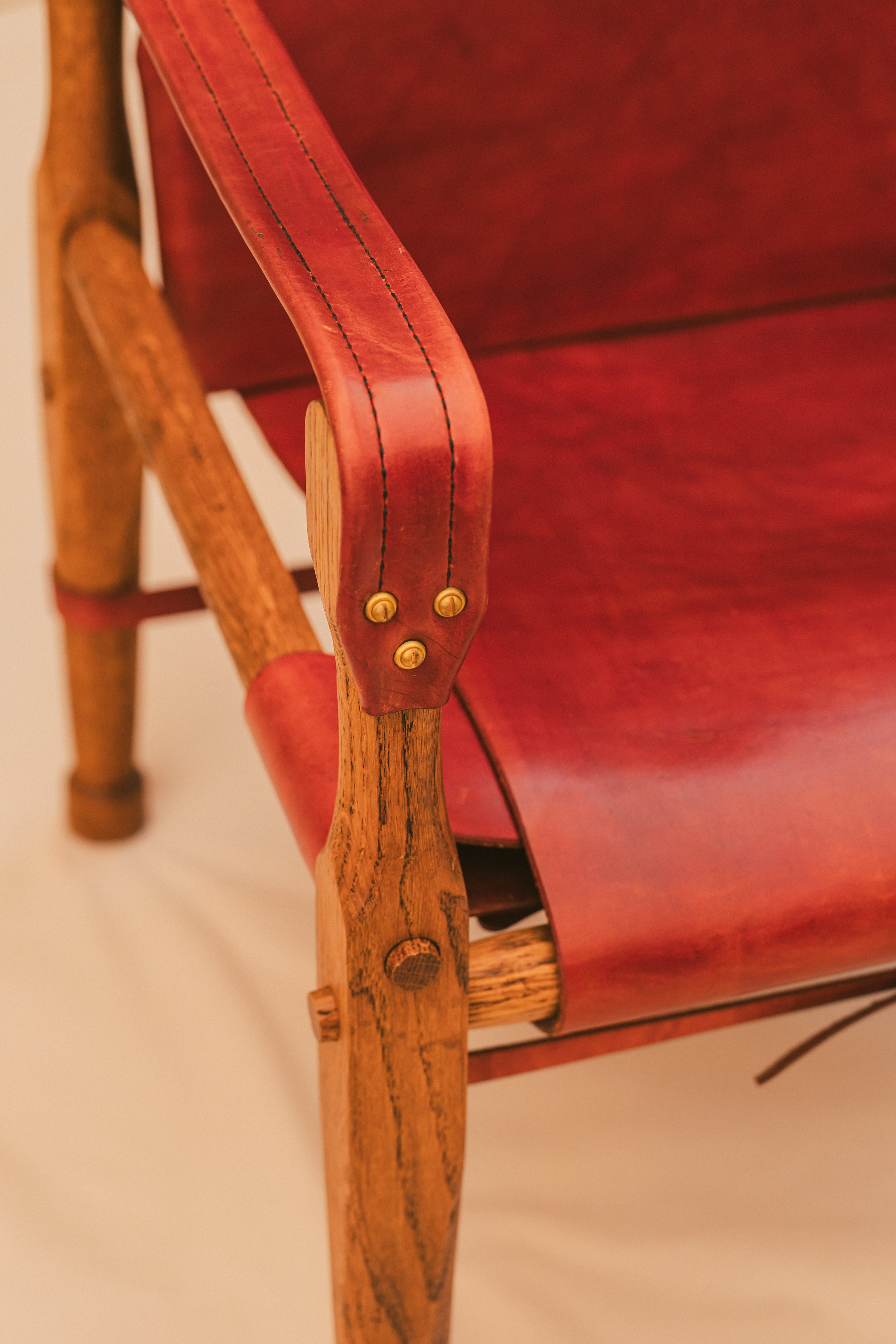 Closeup of Solid Bradd decorative screws and Hand stitched Armrests