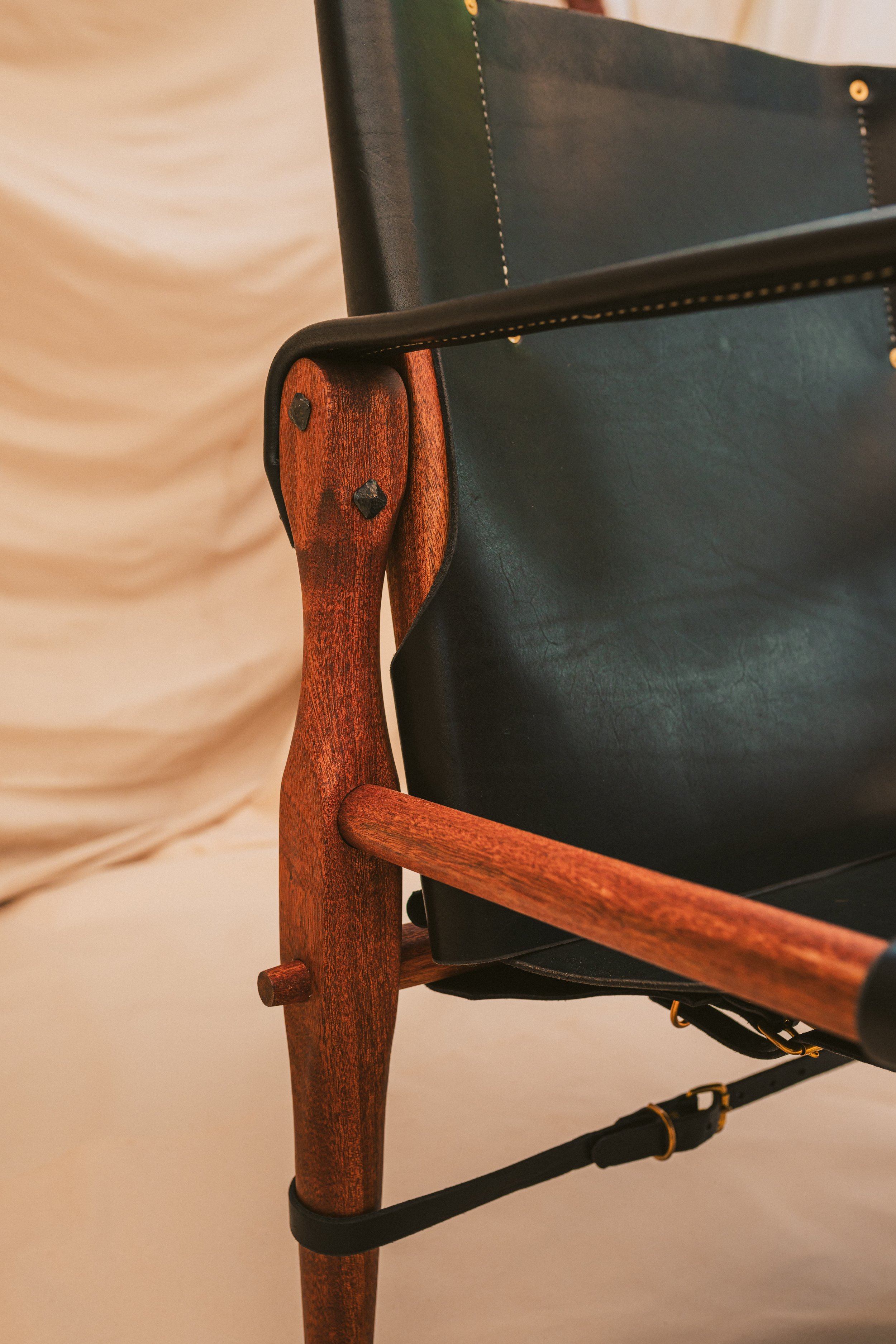 Close-up of mortise and tenon joinery in hand turned mahogany legs. Highest quality of craftsmanship.