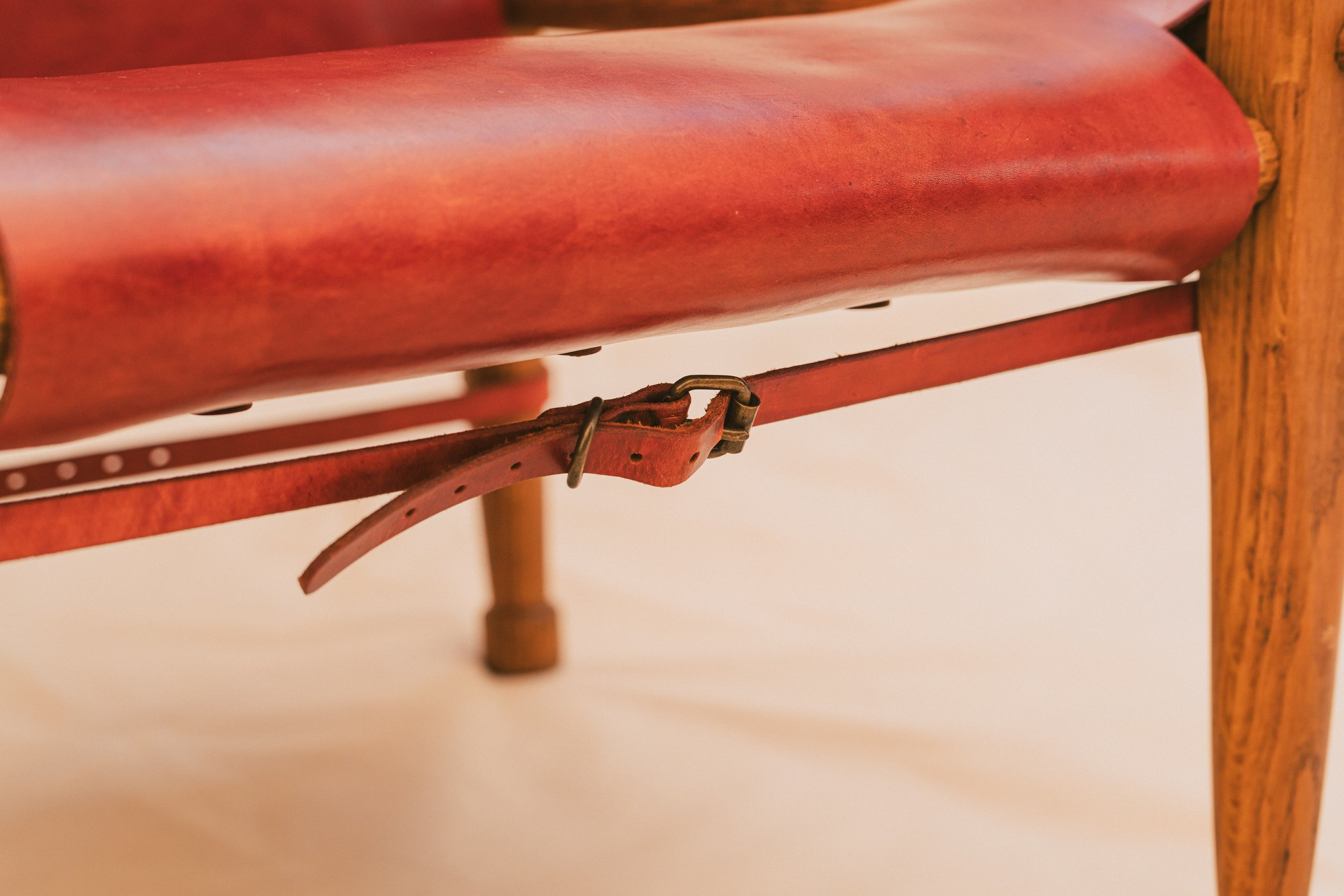 Closeup of Full Grain Leather cowhide chair in Red-Brown. Hand dyed