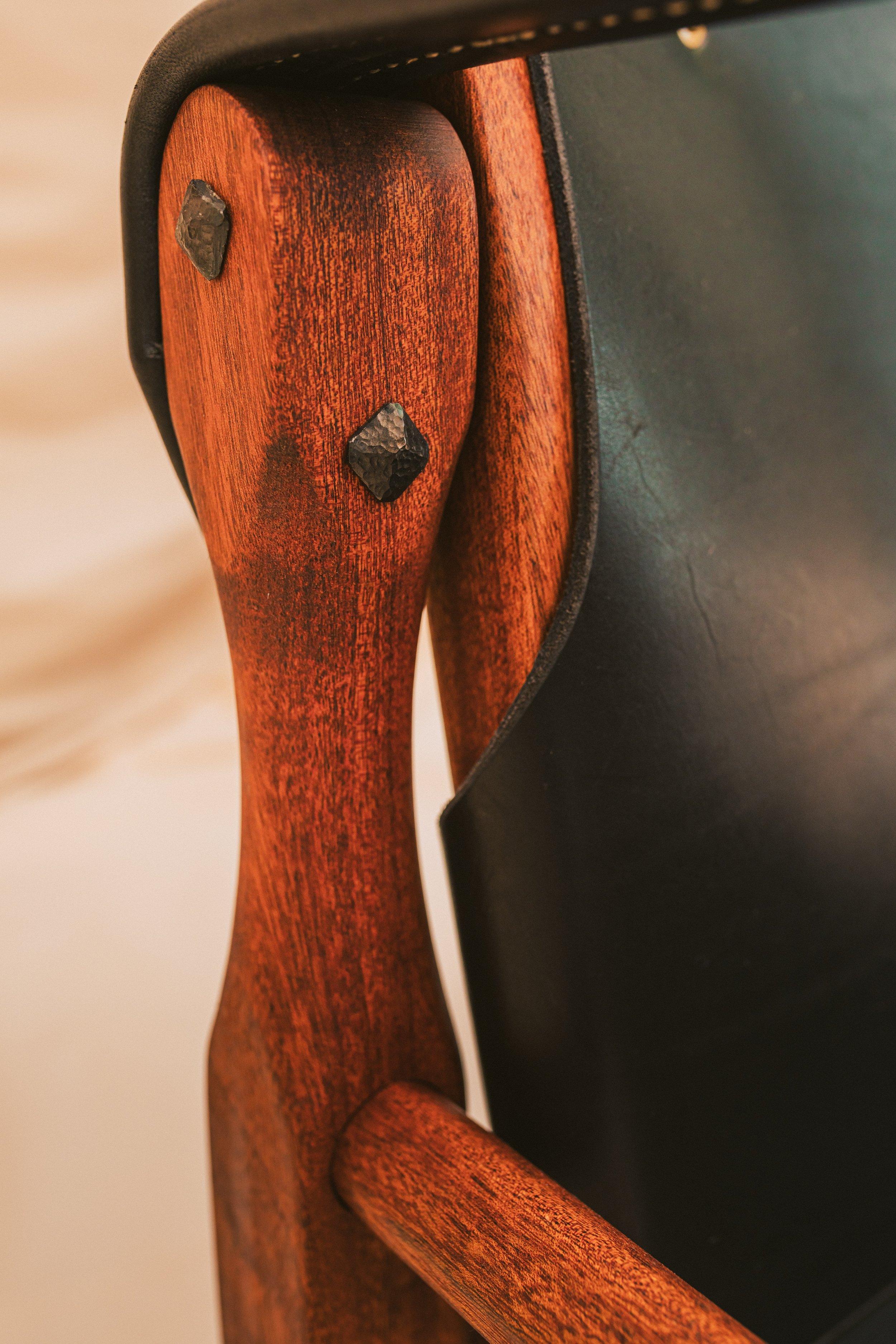 Closeup of hand dressed steel bolts hammered and finished with beeswax. A unique craftsman touch