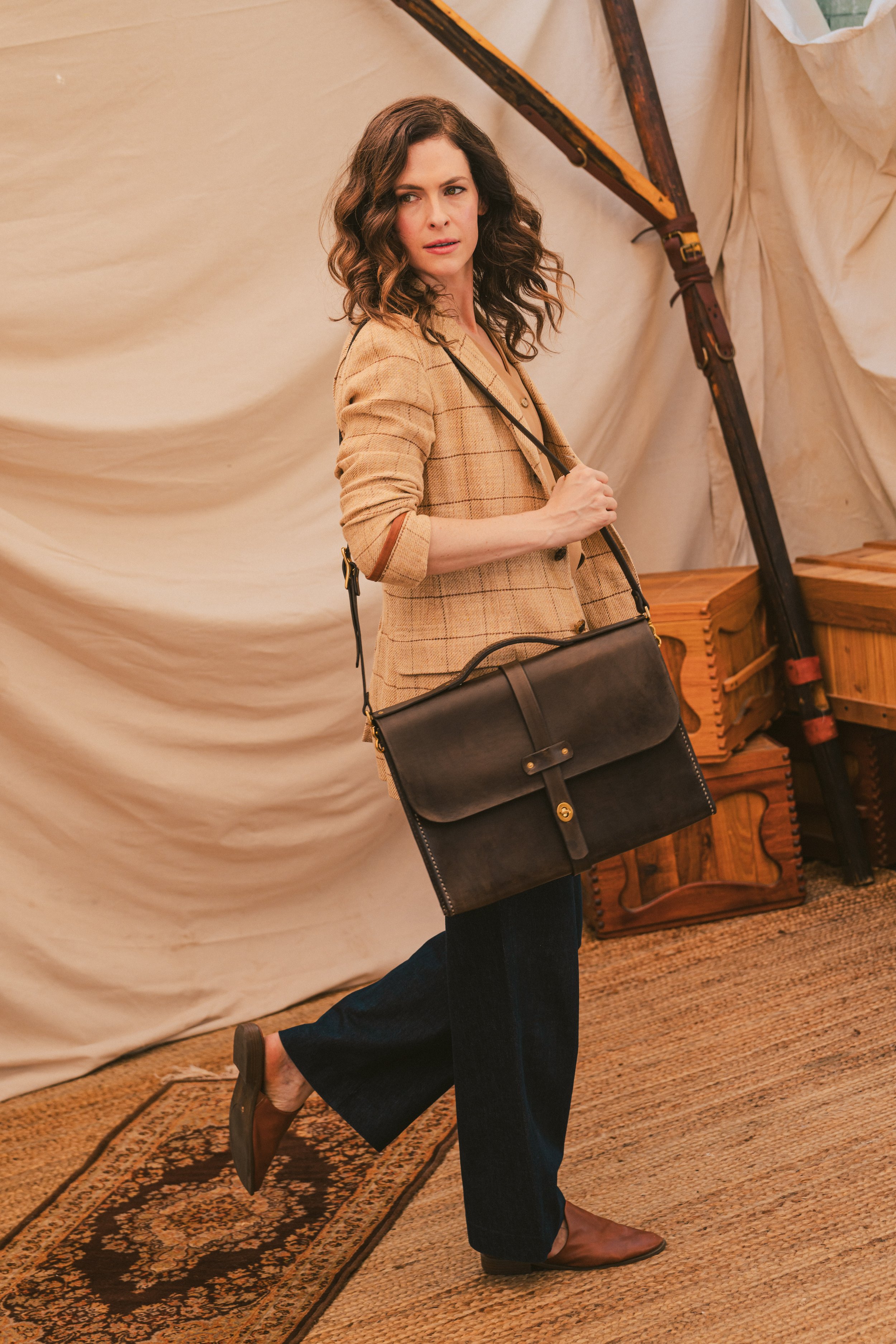 Close-Up of Chocolate Brown Leather Messenger Bag with model "Detailed view of the chocolate brown leather messenger bag showcasing hand-stitched seams and premium vegetable-tanned leather