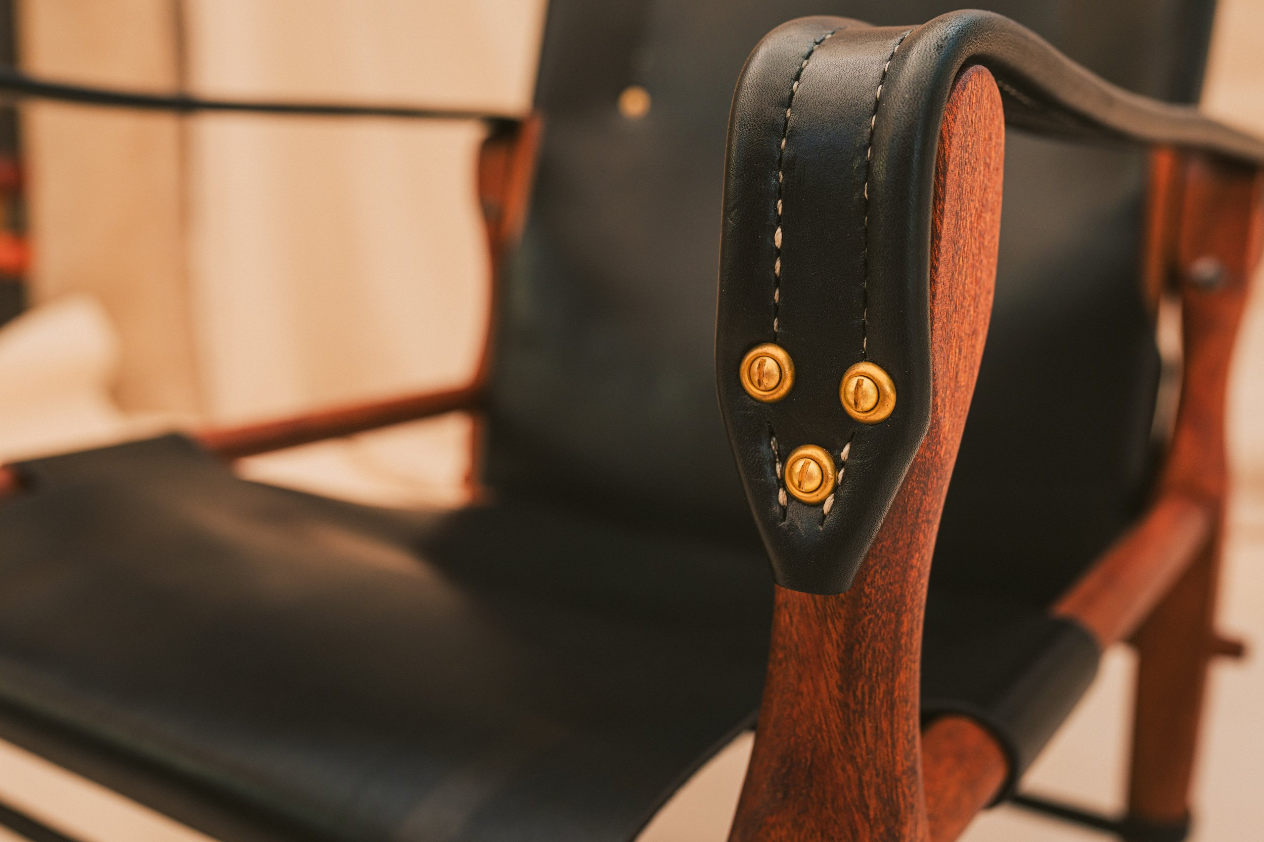 Closeup view of solid brass hardware with executive black leather