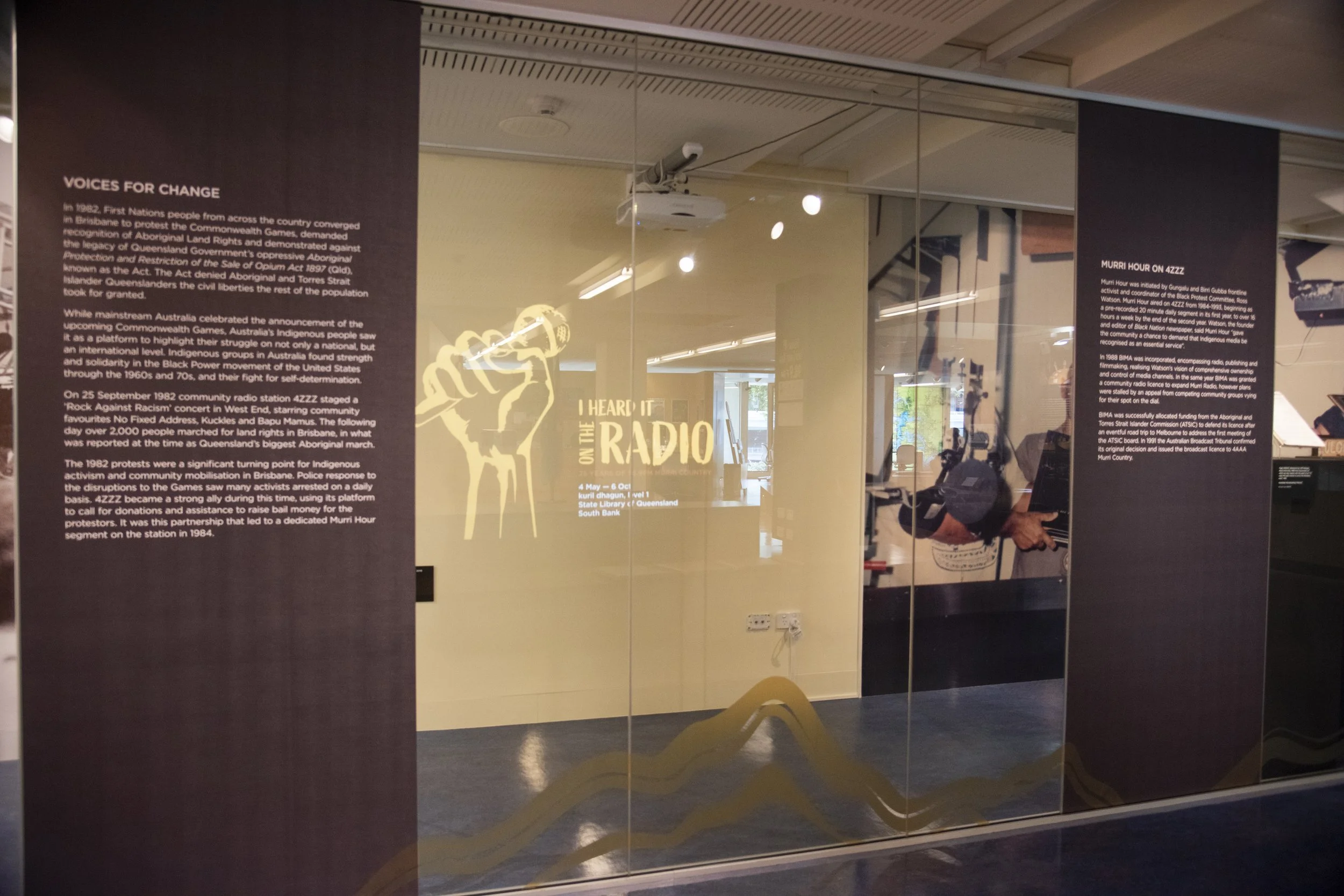 Exhibition display with projected digital stories, featuring directional speakers for immersive display