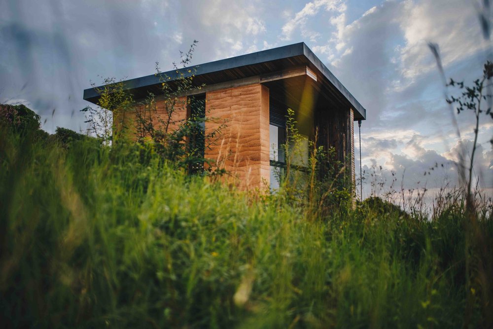 A Birdhouse in the tall grass on the hillside