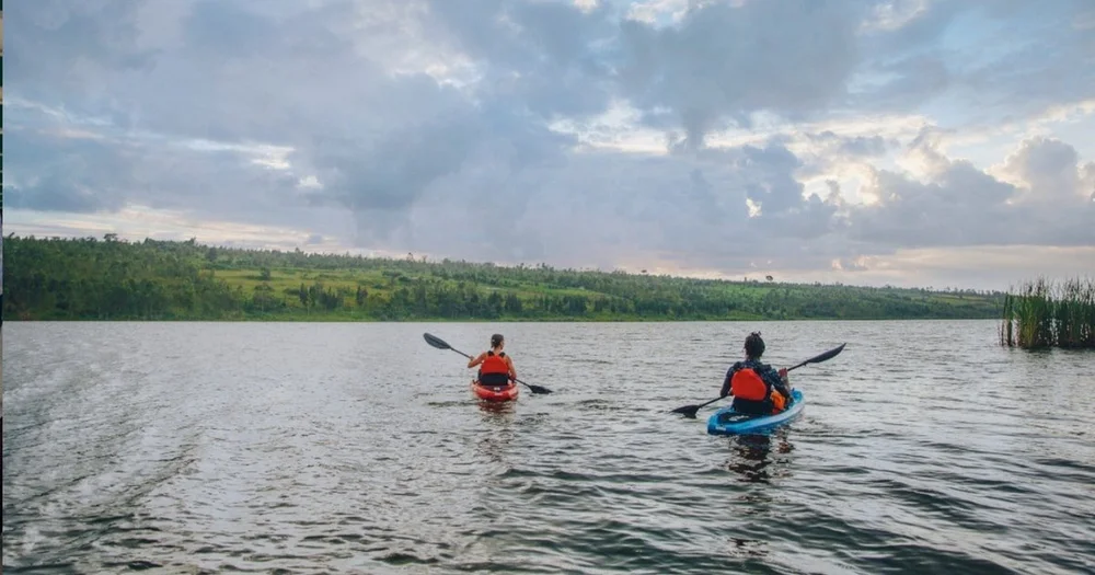 Two guests kayaking on Lake Muhazi