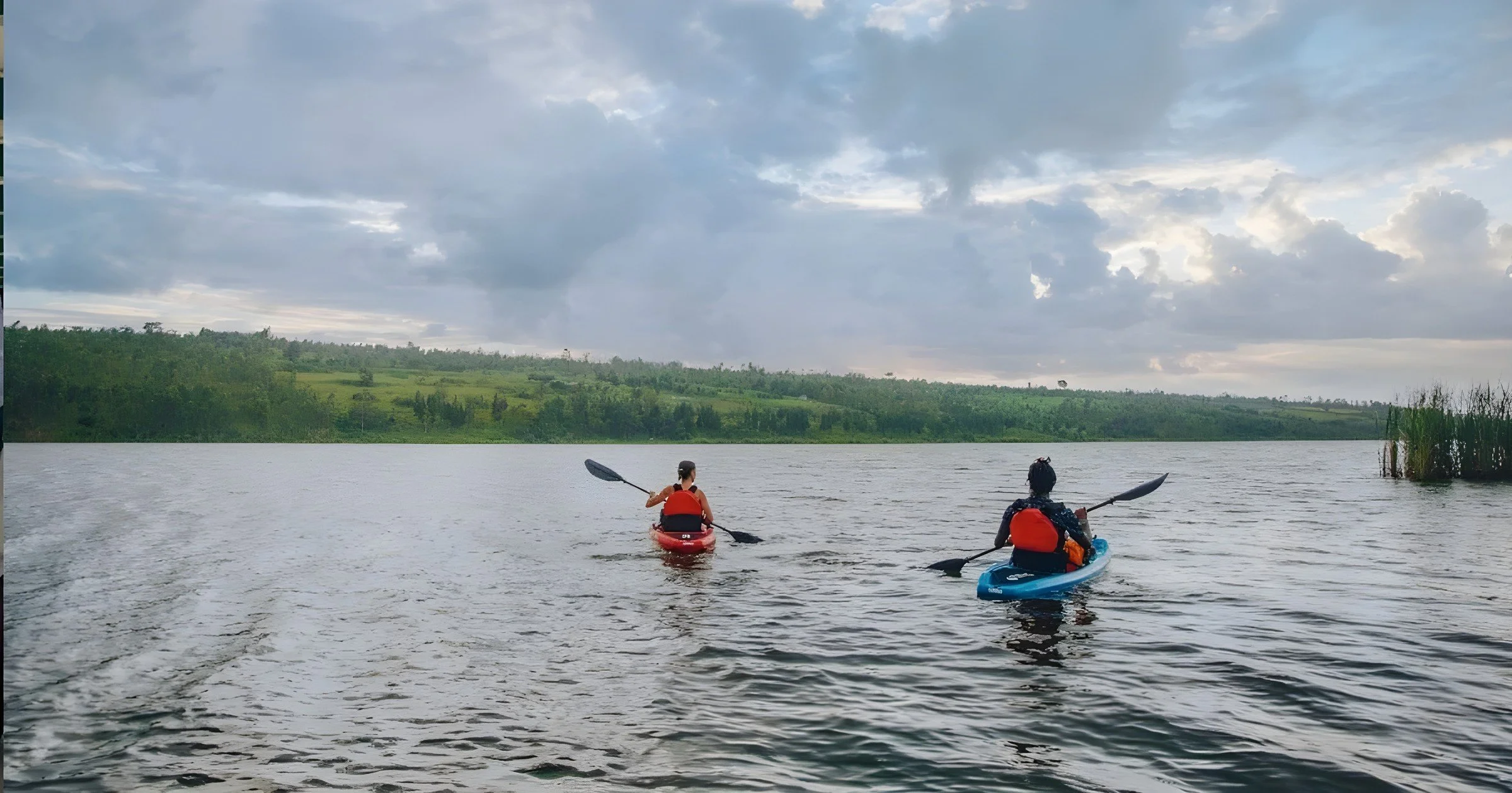 Two guests kayaking on Lake Muhazi