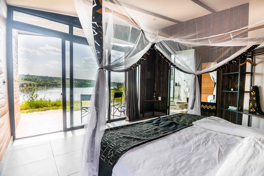 The Pod bedroom, with the bed facing the lake through glass doors