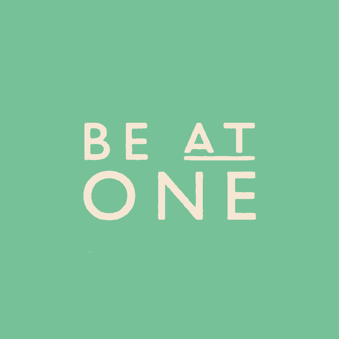 Text on a green background that reads "BE AT ONE" with the letter 'A' underlined.