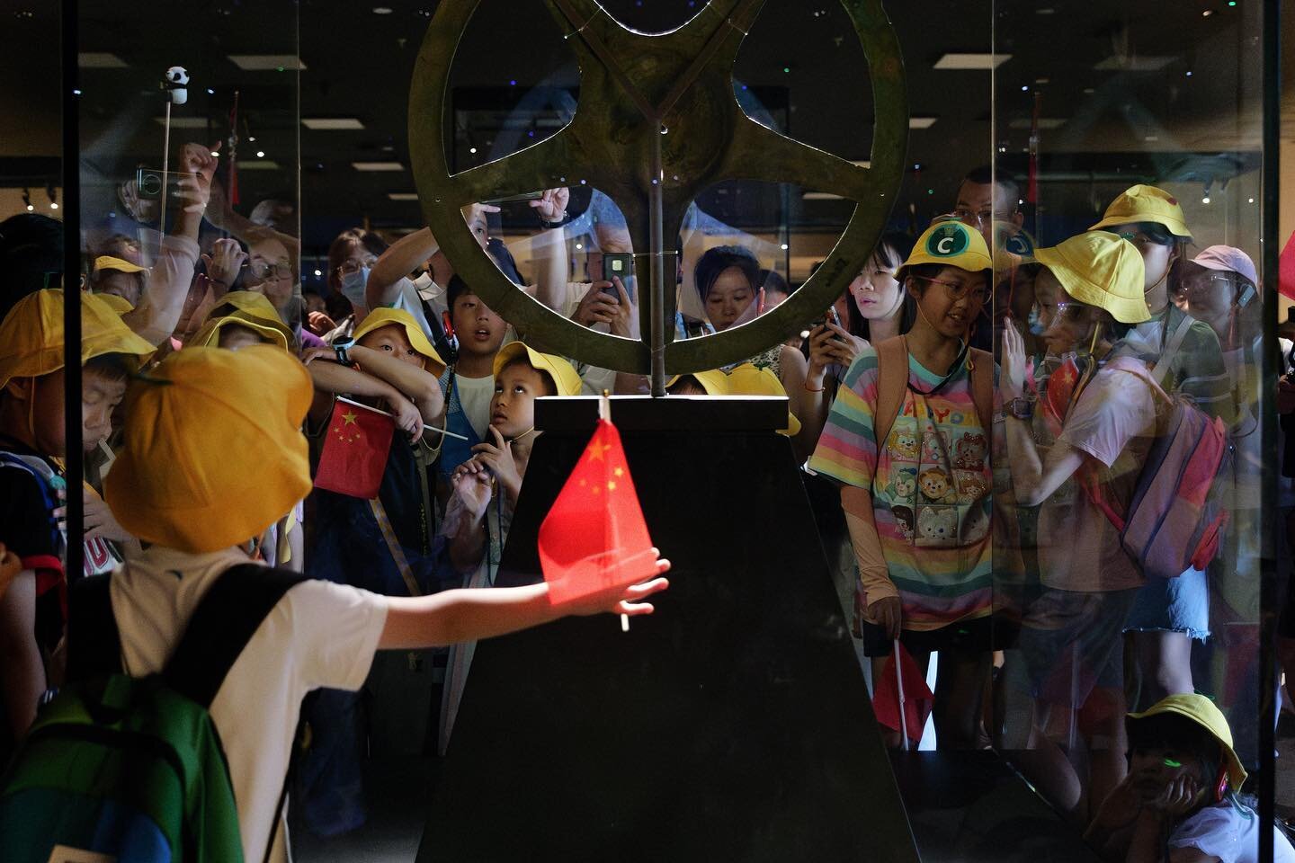 Young students holding Chinese flags surround the Shang Bronze Sun-Shaped Object, a grade-one Chinese national treasure excavated from the Sanxingdui ruins, in Sichuan&rsquo;s Sanxingdui Museum on August 15, 2023. 

#scmp #scmpnews 
#videojournalism 