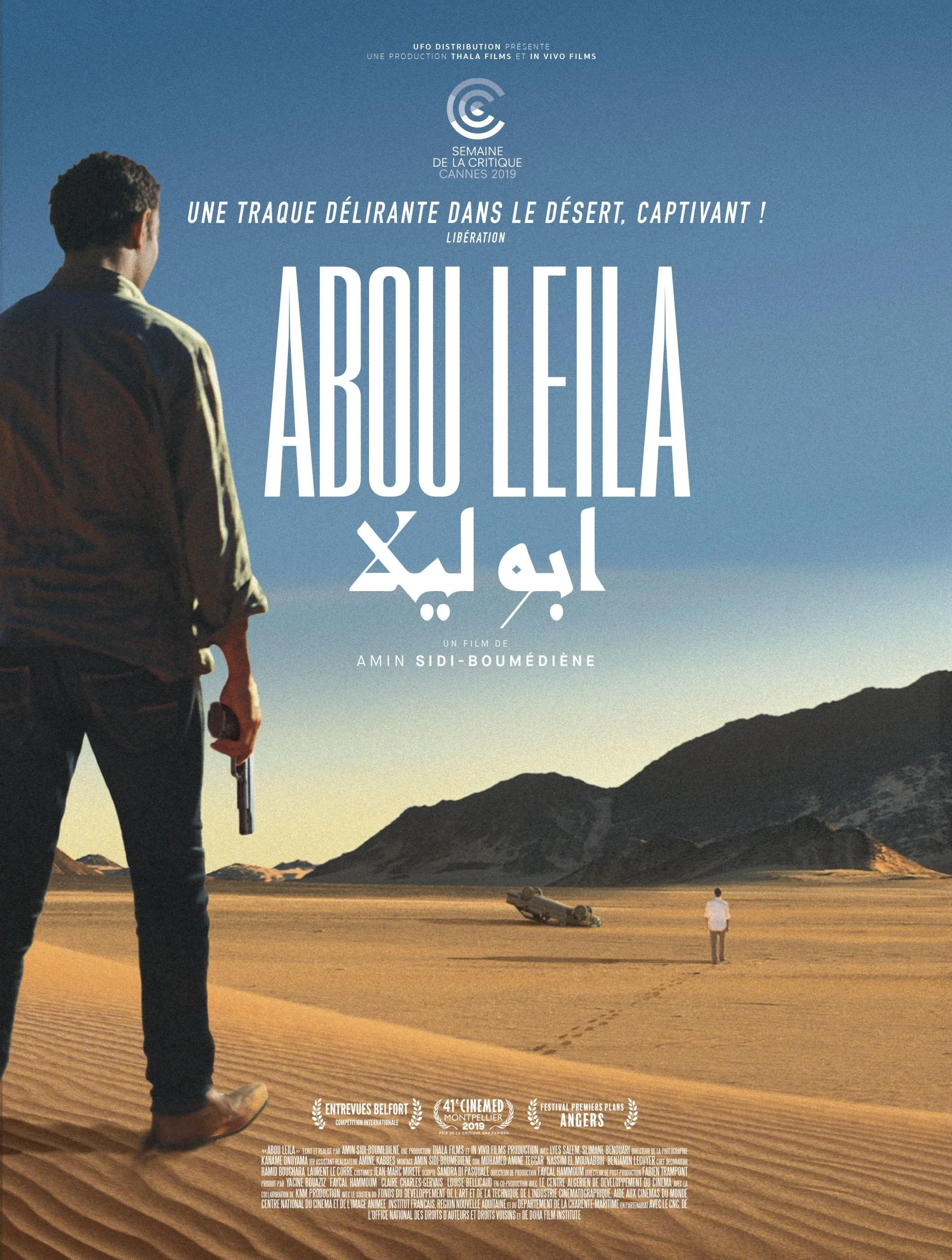 A movie poster for "Abdou Leila" showing a man holding a gun and walking through a desert with mountains, and a woman standing in the distance near a toppled car.