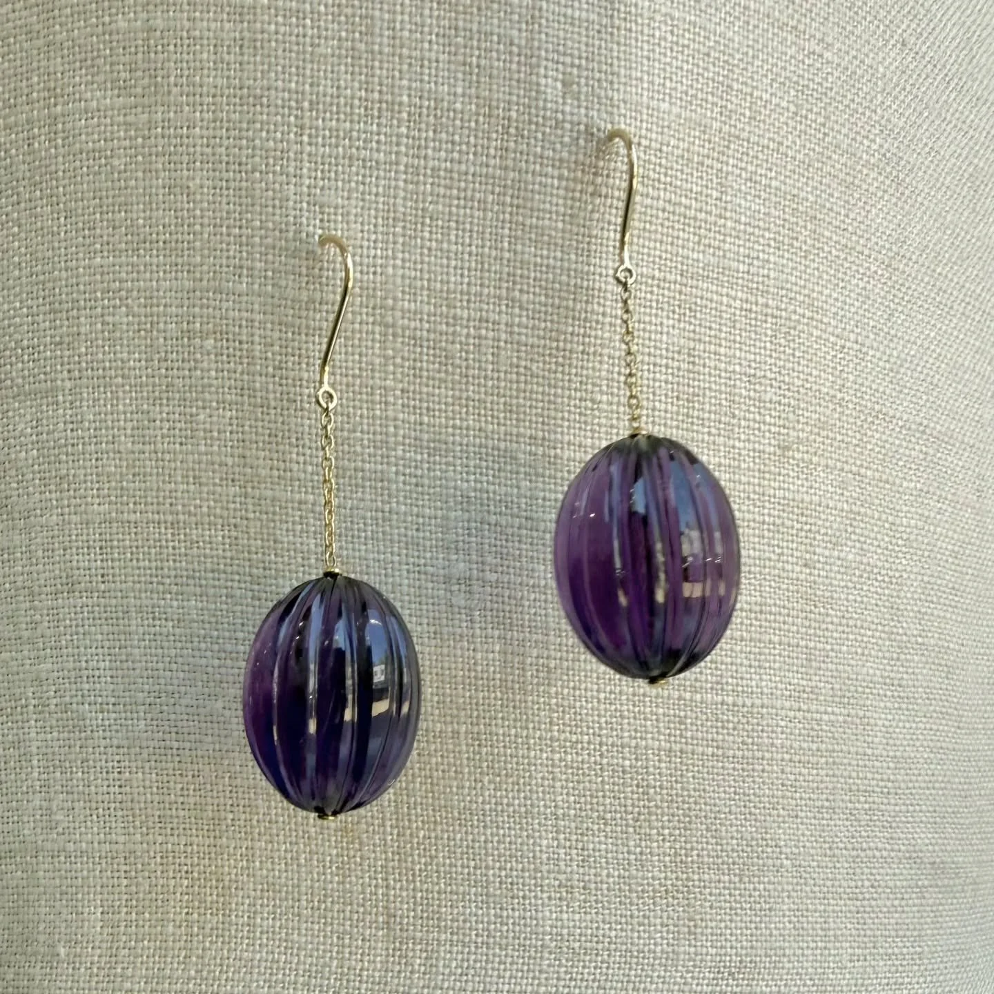 Carved amethyst dangles.