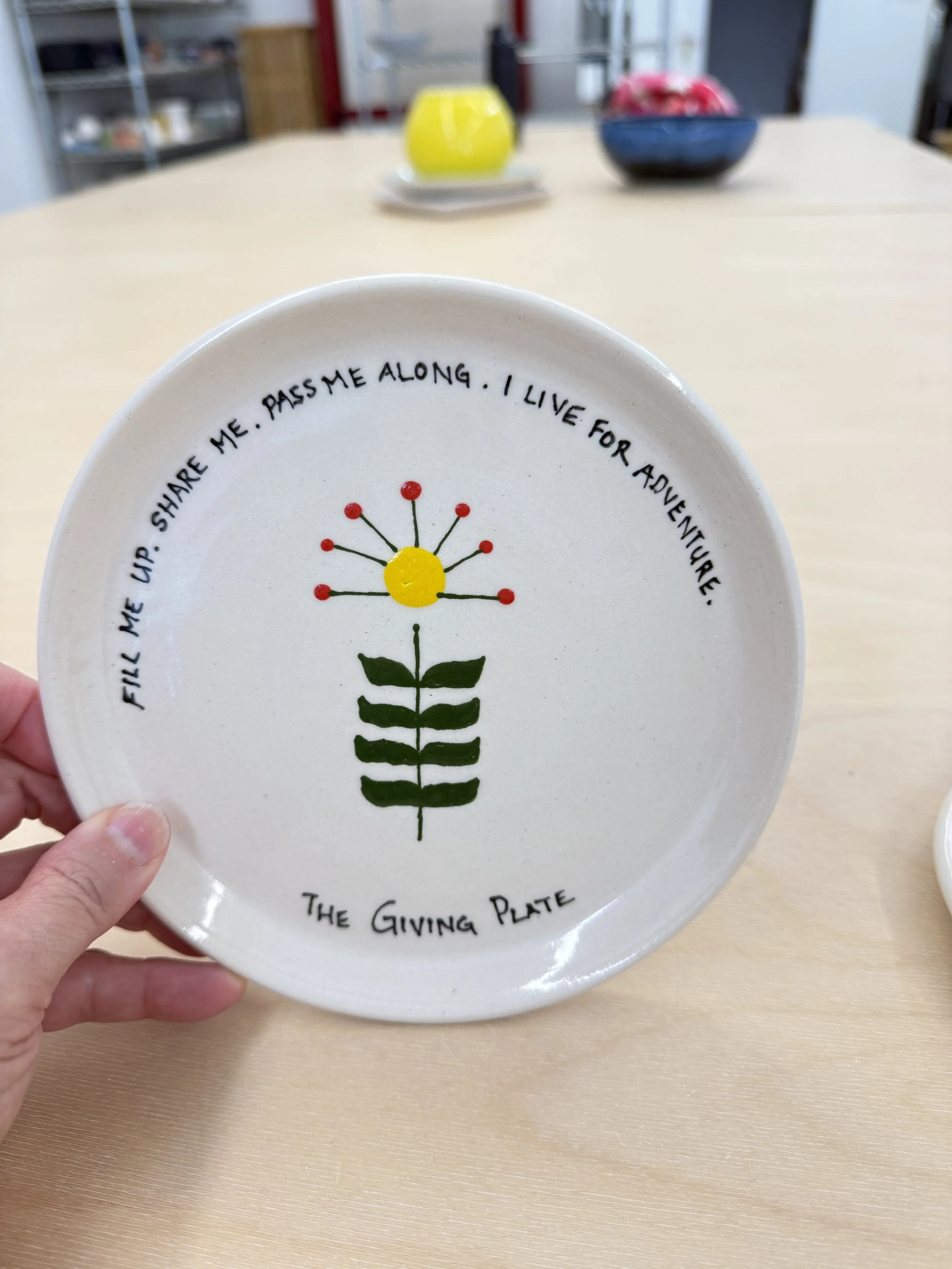 A decorative plate with a flower illustration and inspirational quote.