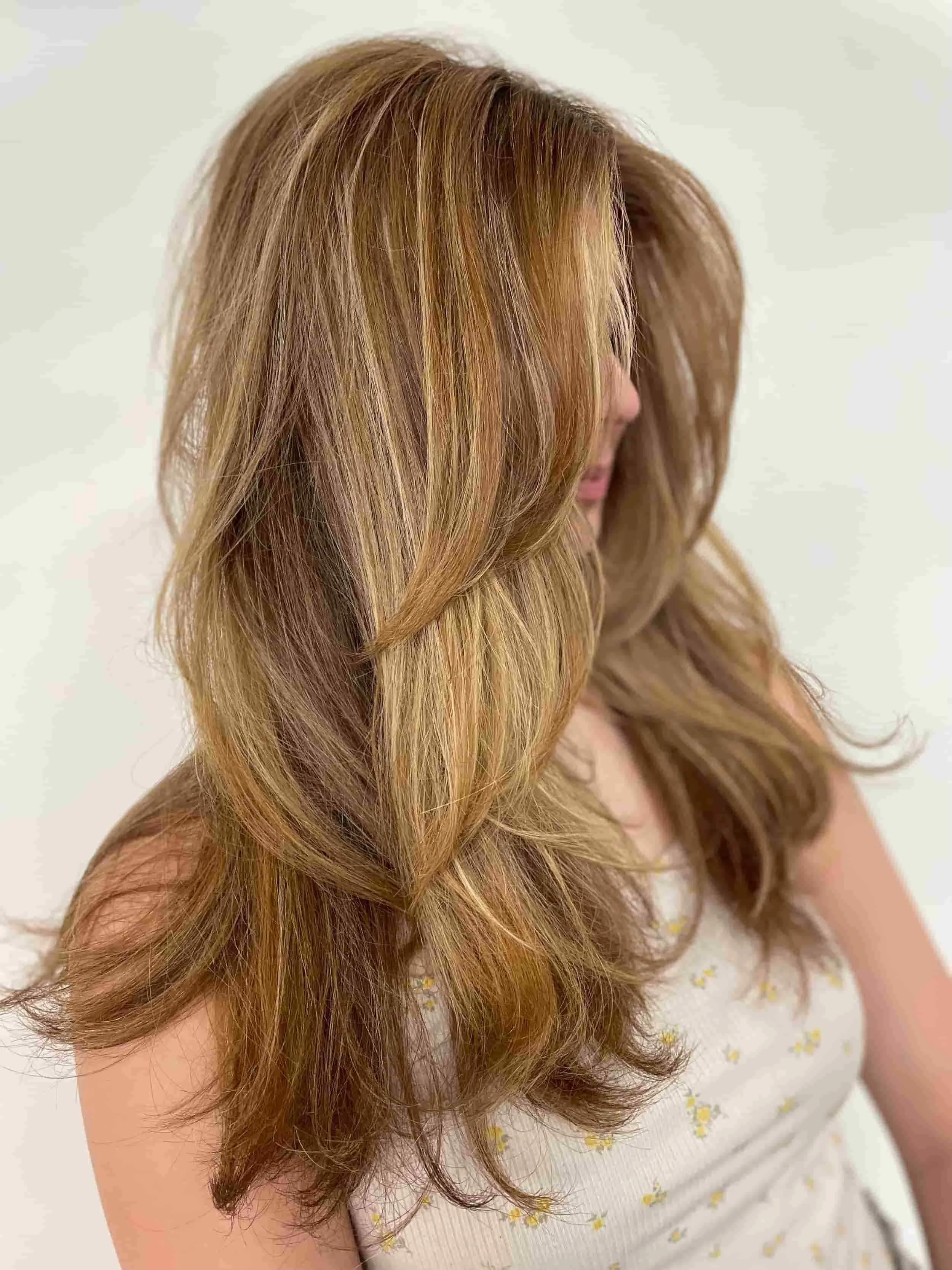 Here is an image of a woman with , beautiful blonde long layered hair