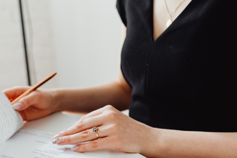 Woman filling out paperwork to insurance for getting her wig expenses covered
