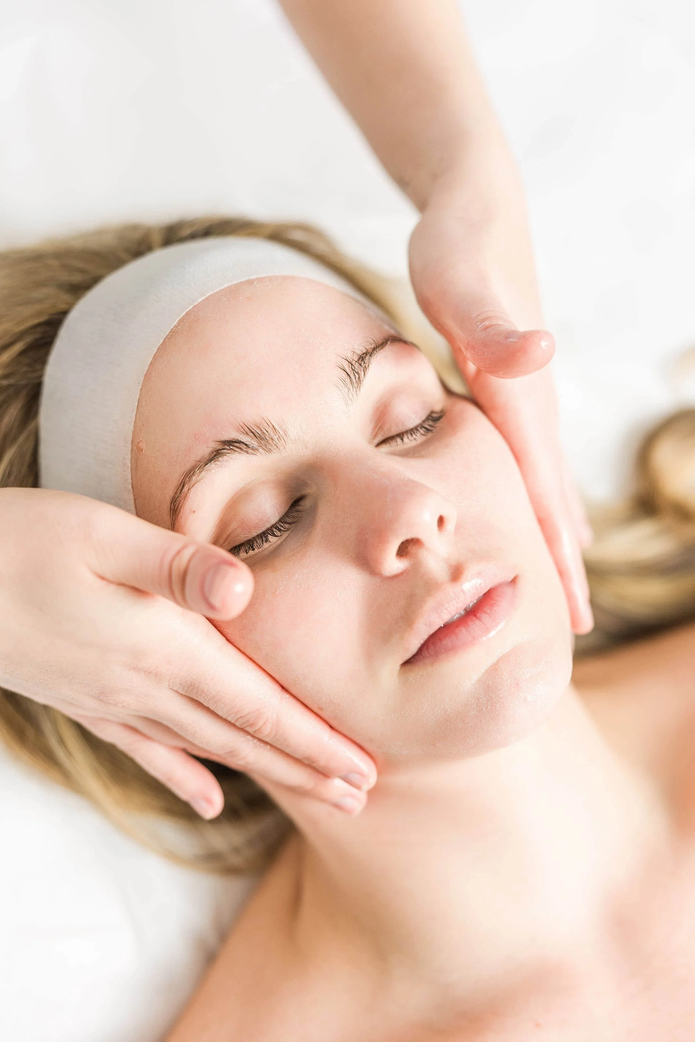 Here is an image of a client at bLUXE getting a european luxury facial. She is relaxed and peaceful and her skin is glowing