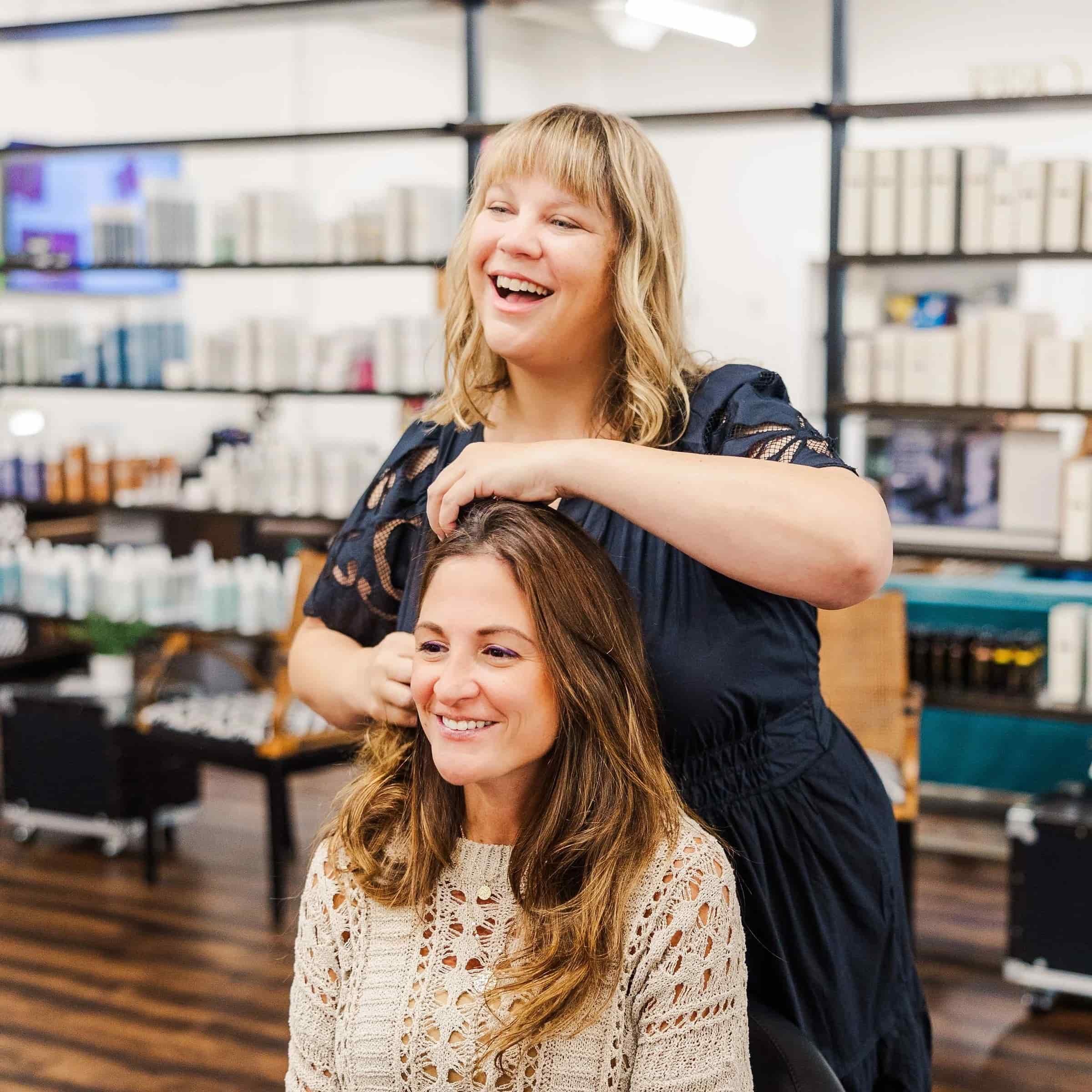 Here is bLUXE owner discussing a color balance with her brunette client in the Medway Studio