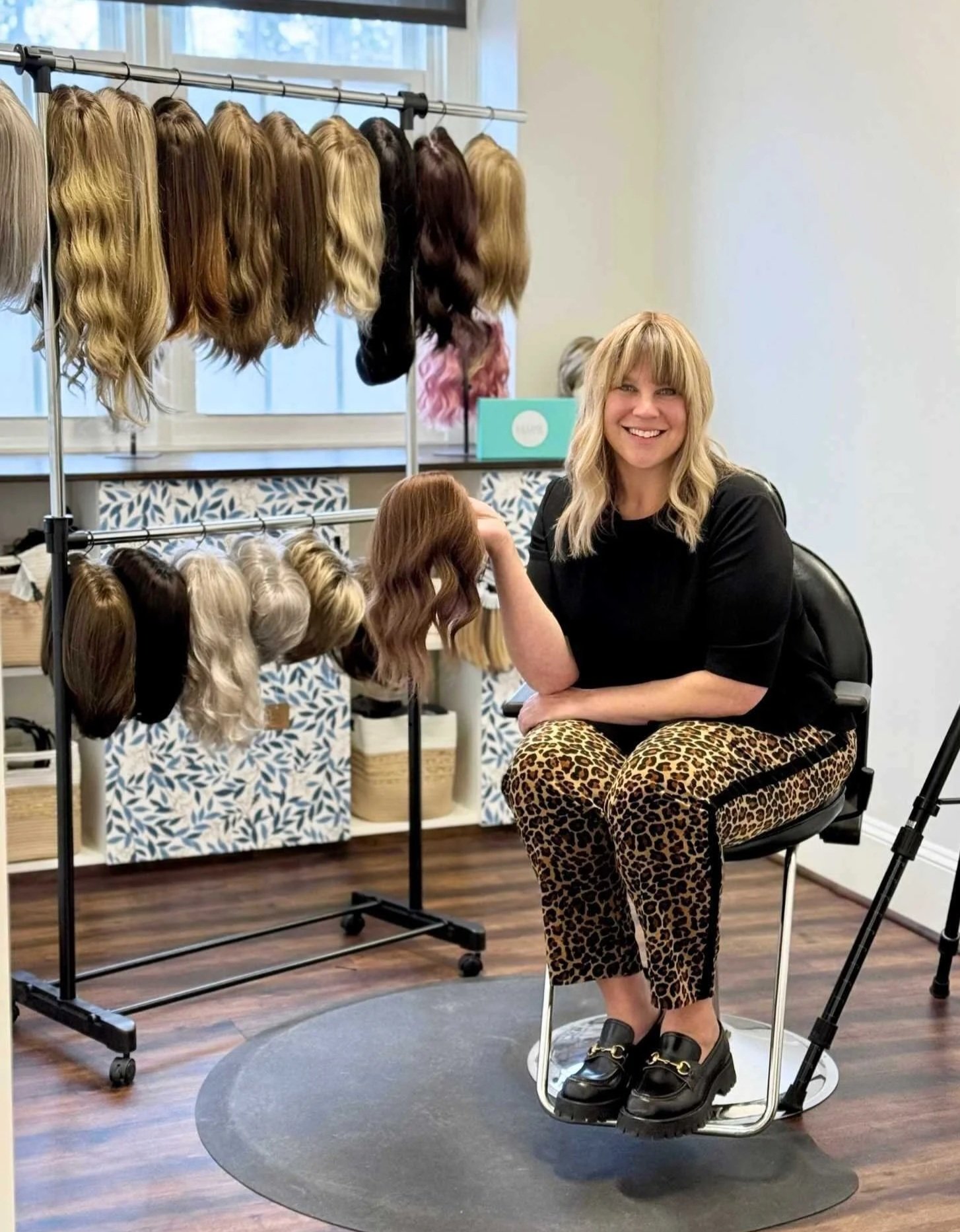 This is an image of Heather Cohen, bLUXE owner and wig specialist in her private wig shop in Medway, MA