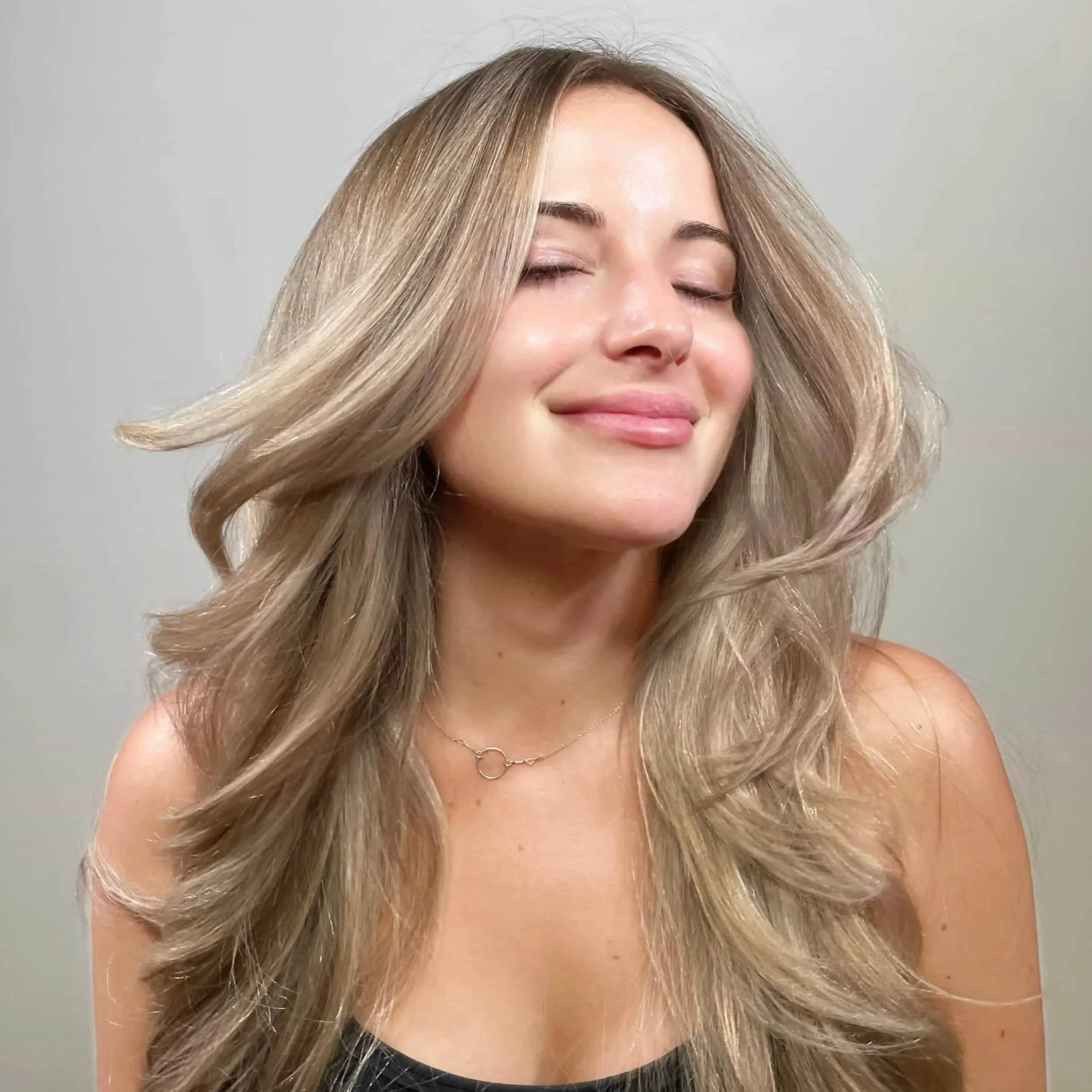 Here is an image of a hair client who had a full highlight and root tap and long layered cut for her ashy blonde hair