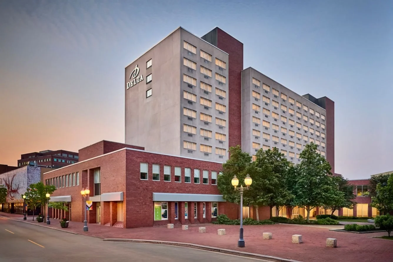 Multi story brick and cement building with the logo Delta on the side