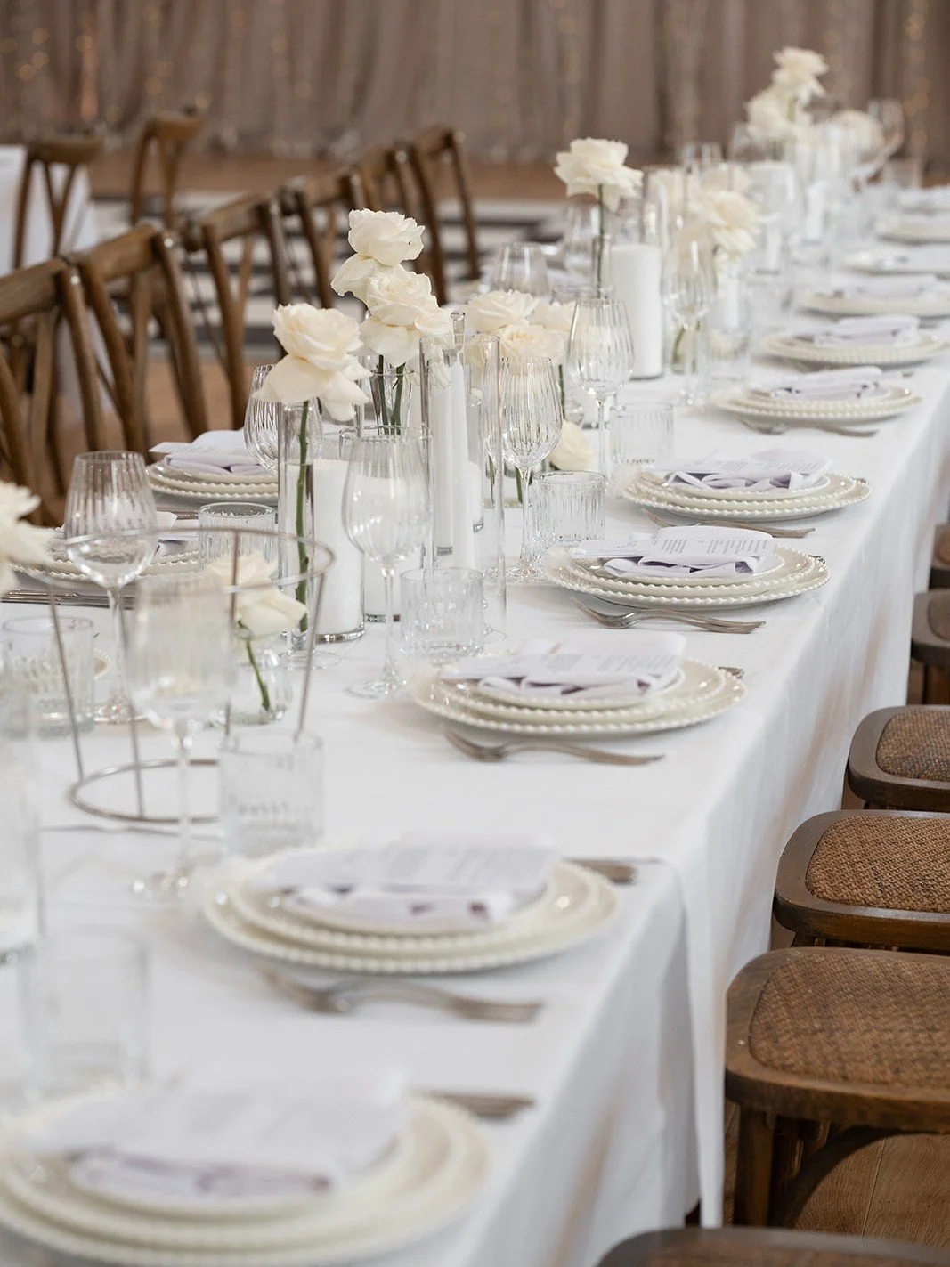 An all-white tablescape, with plenty of texture and a few simple details that make all the difference. 

Layered plates, cut glass and white roses. A timeless look for Kate &amp; Shaun&rsquo;s day.

Featuring: 
Parla Dinnerware
Lina Glassware
Cristal