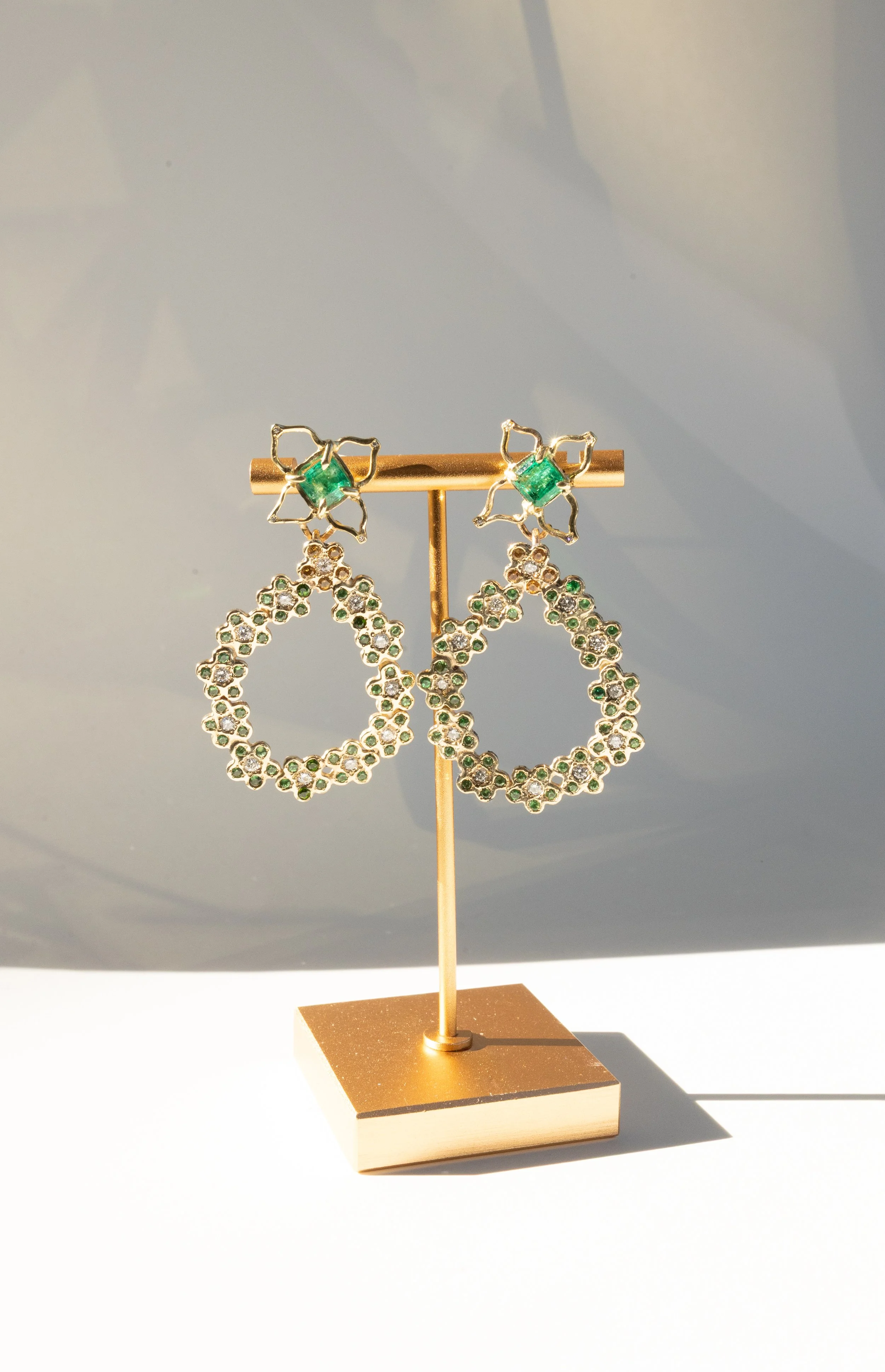 emerald earrings on stand .jpeg