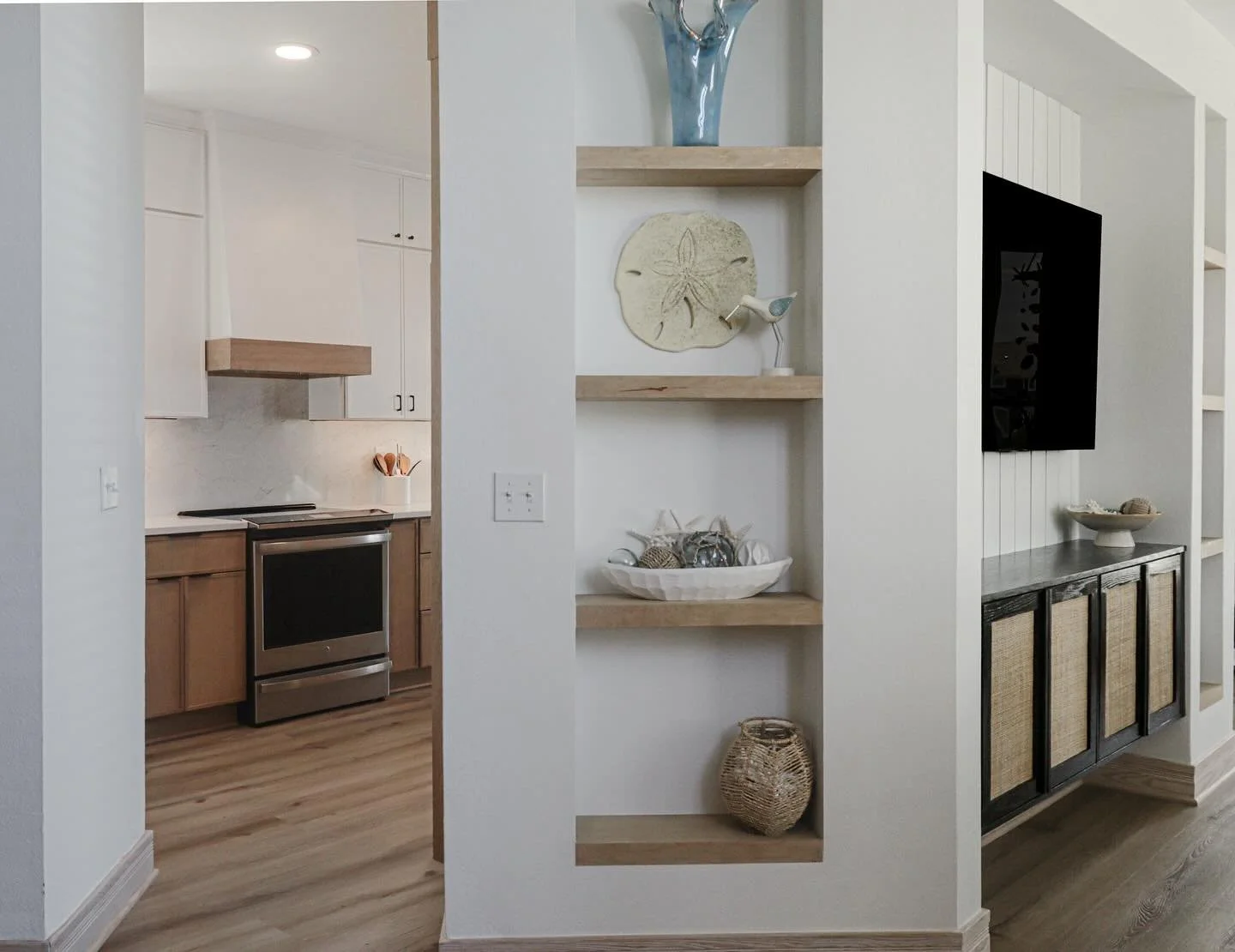 This project started with these custom built ins and cabinetry wall to update the space in a way that actually works for our clients.
The kitchen came later, but you would never know it. Even though these renovations happened at different times, the