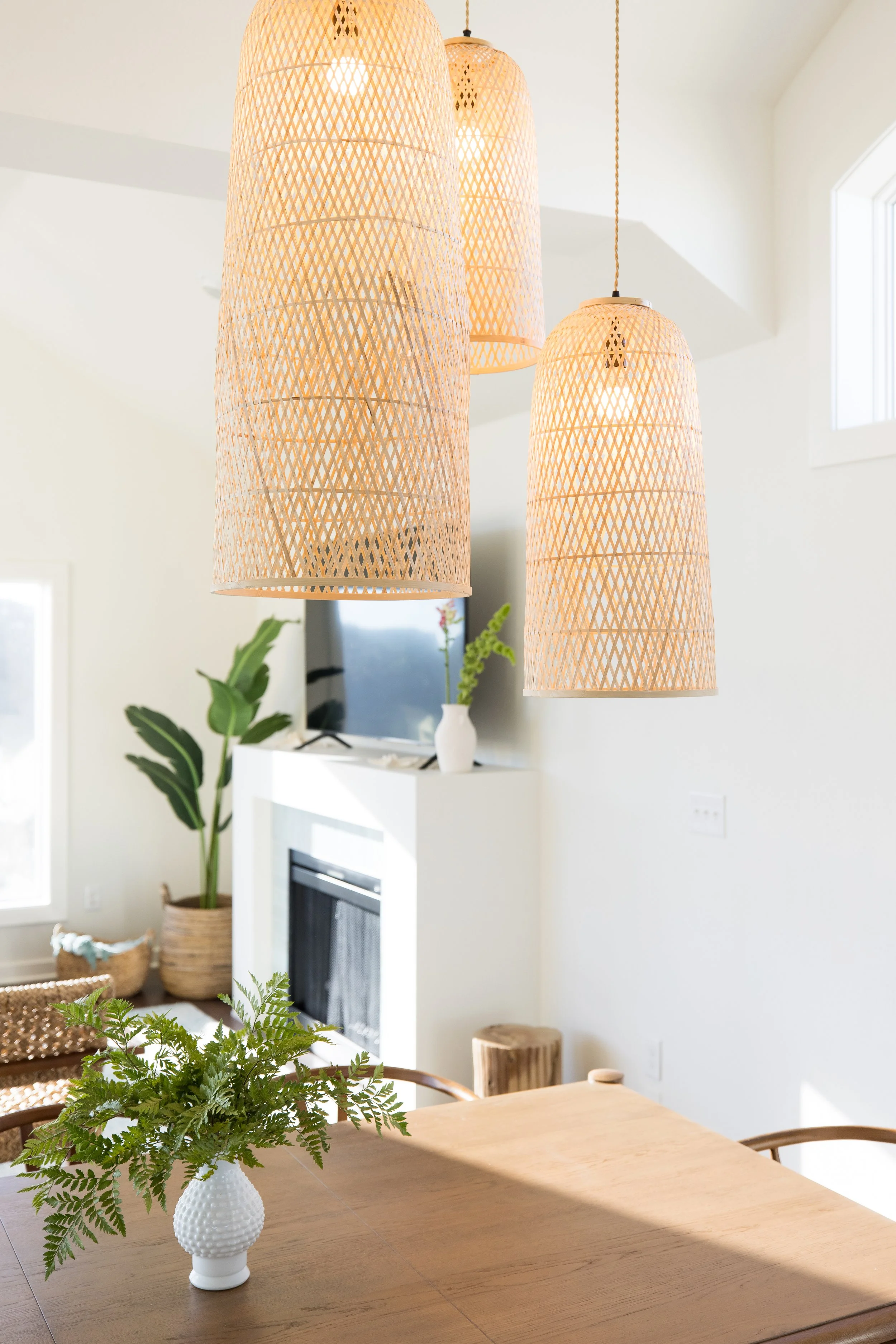 Airbnb staging and design in corolla Bay with rattan light fixture and fireplace renovation