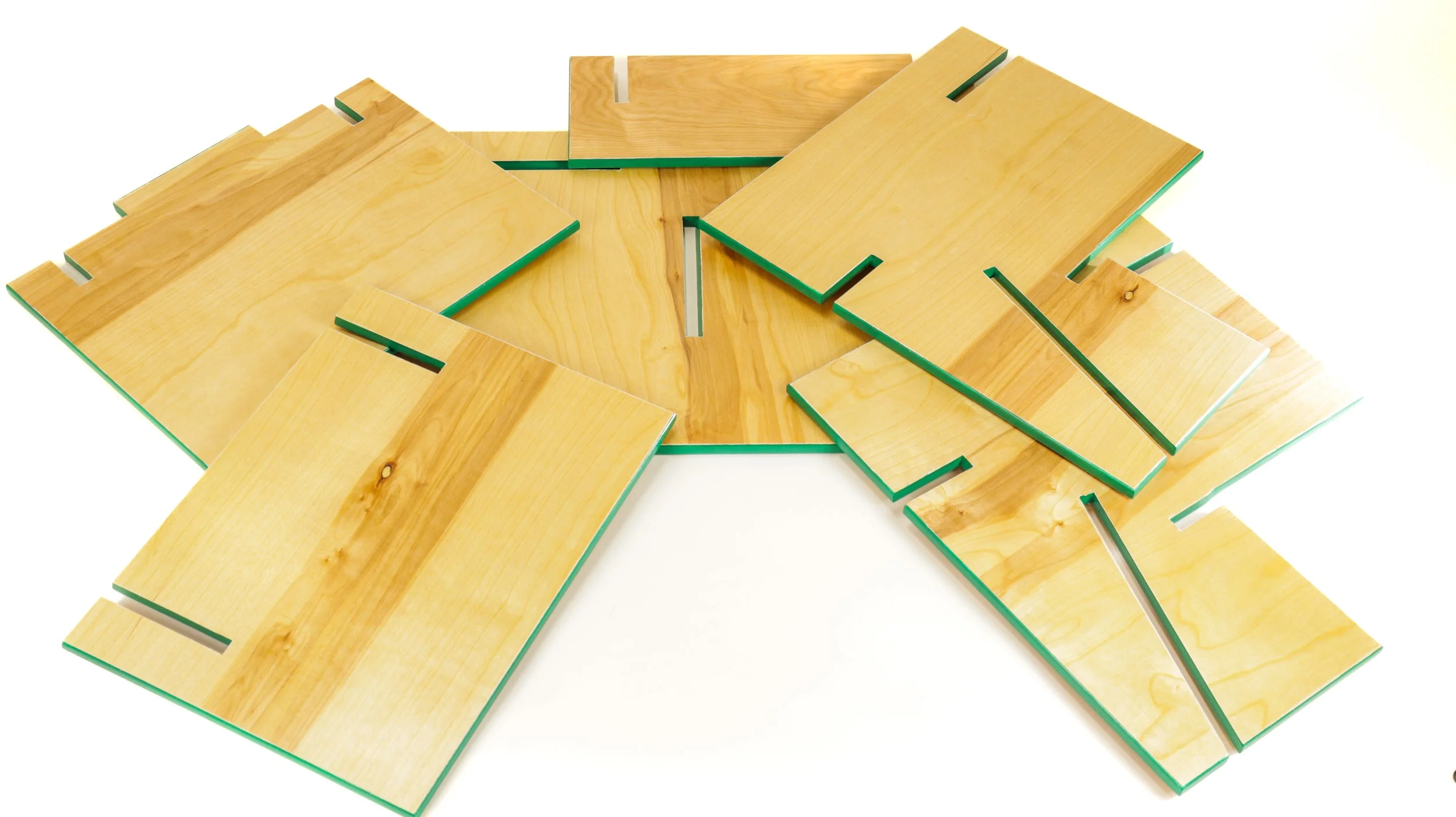 Set of flat pack chair pieces with green painted edges 