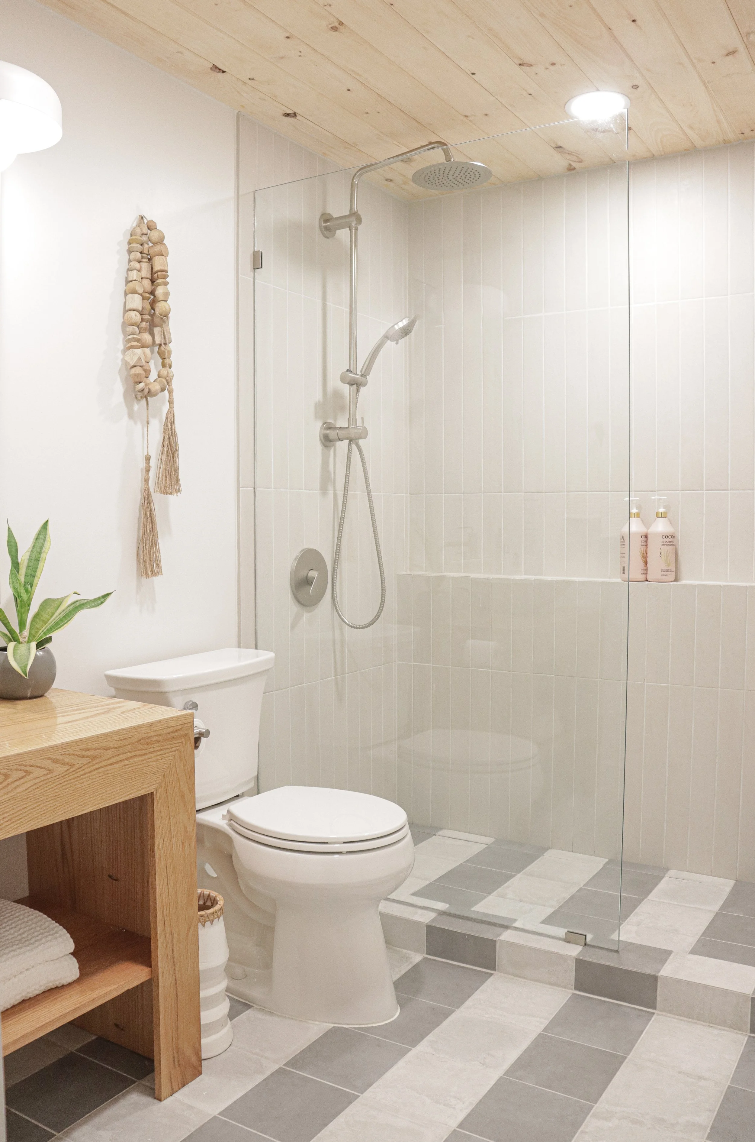 Striped tile and wood ceiling bathroom remodel in Nags Head with custom wood vanity 