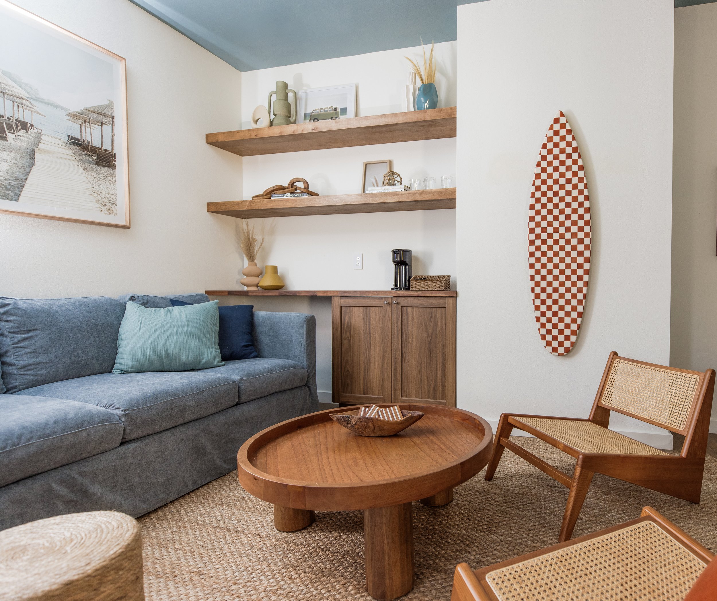 Corolla Airbnb living room lounge space design with custom slipcover sofa, wood accent chairs and Ikea cabinets 