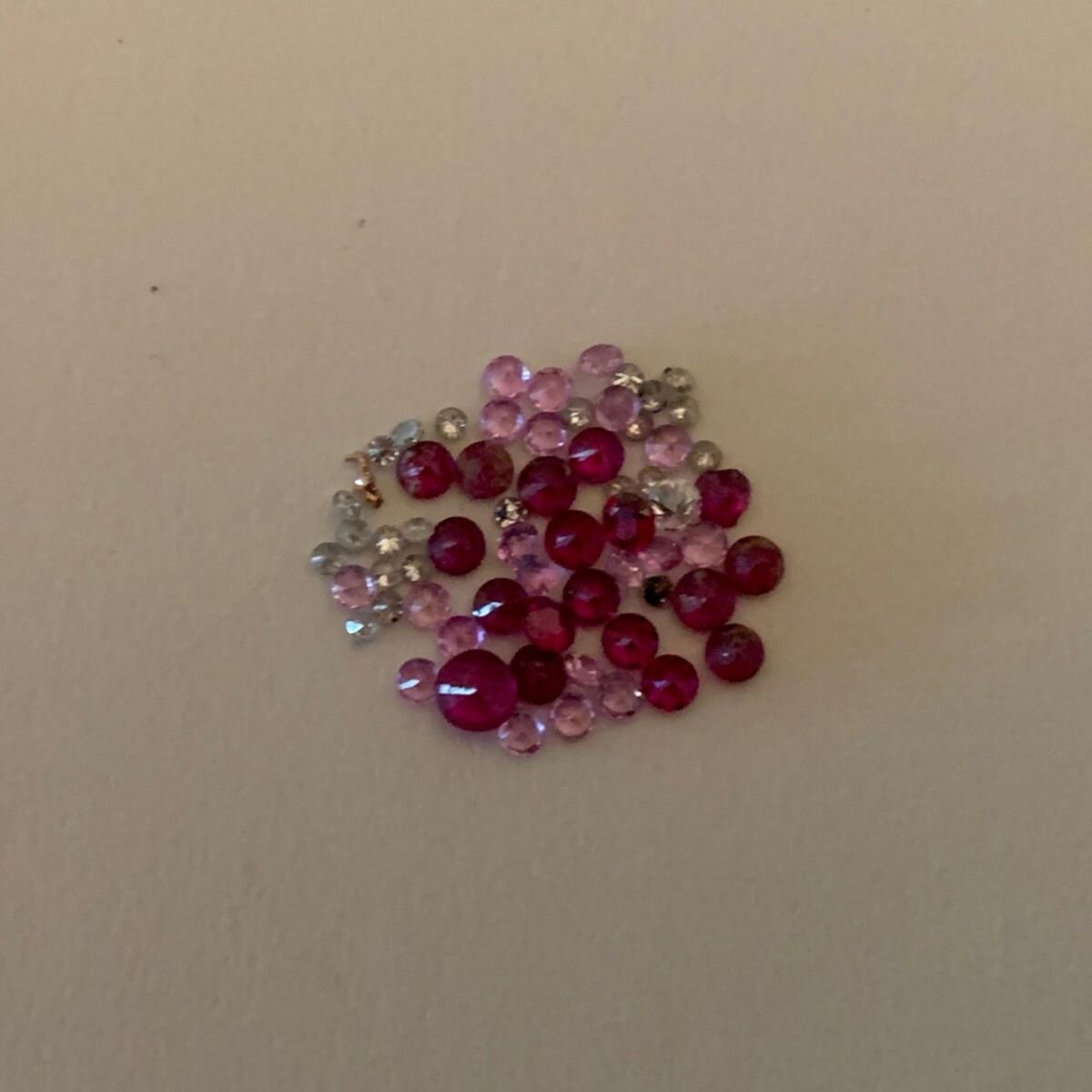 Rubies, Diamonds, and Sapphires laid out for a custom Rose Gold Signet Ring by Jane Becker for JBJewels.jpeg