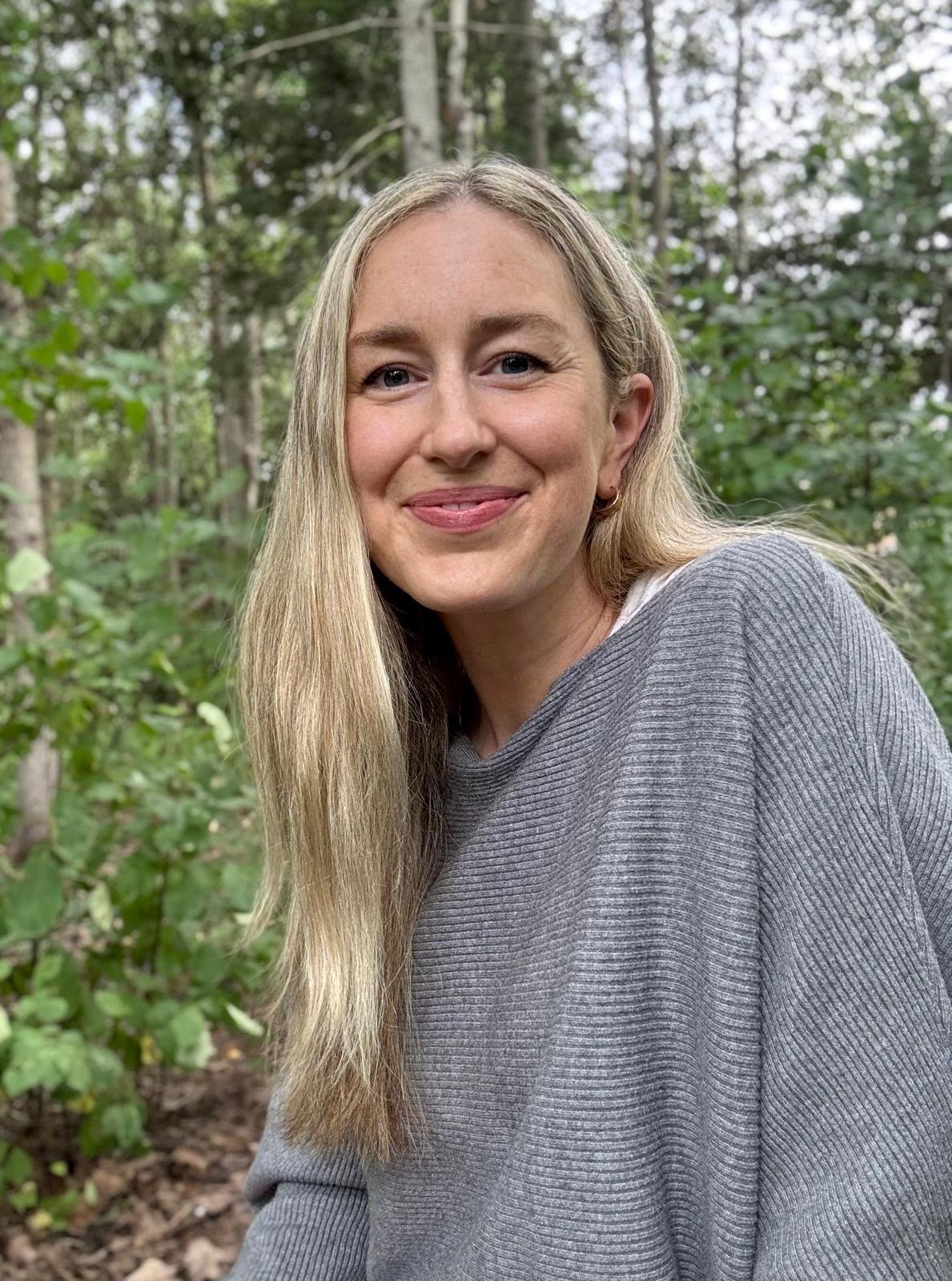 Sydney Davidson, RCC therapist and counsellor, smiling portrait, specializing in trauma, grief, and emotional healing.