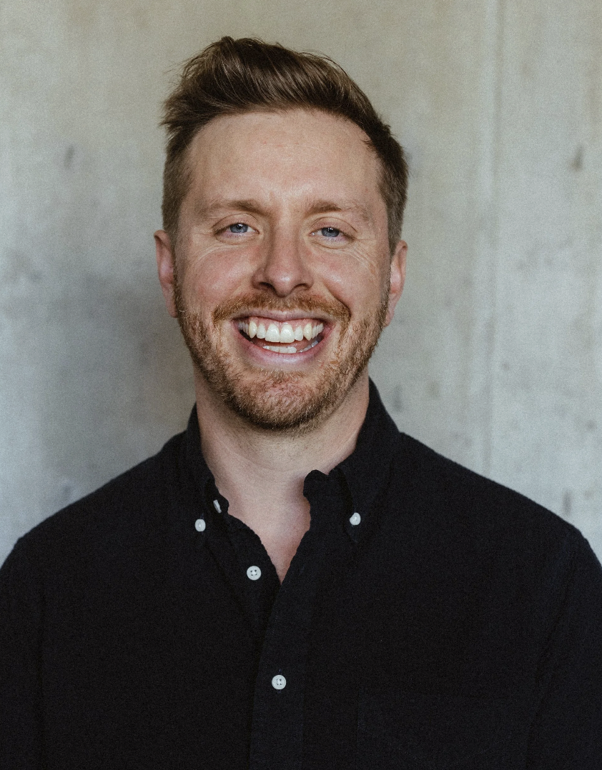 Benjamin Weidman, RCC therapist and counsellor, smiling portrait in black shirt, specializing in trauma, burnout, and life transitions.