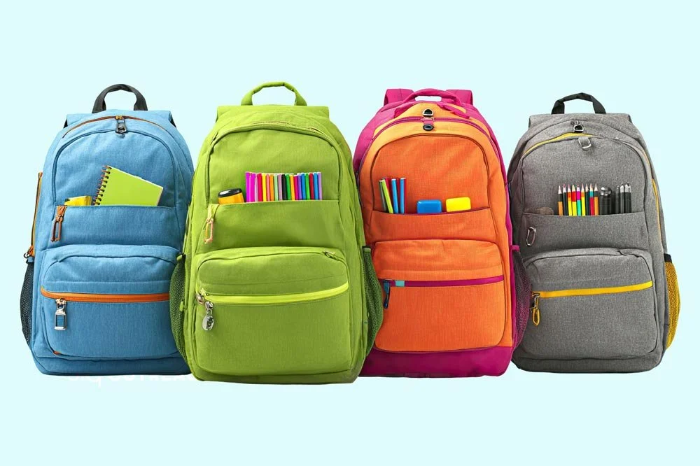 row of colorful school backpacks
